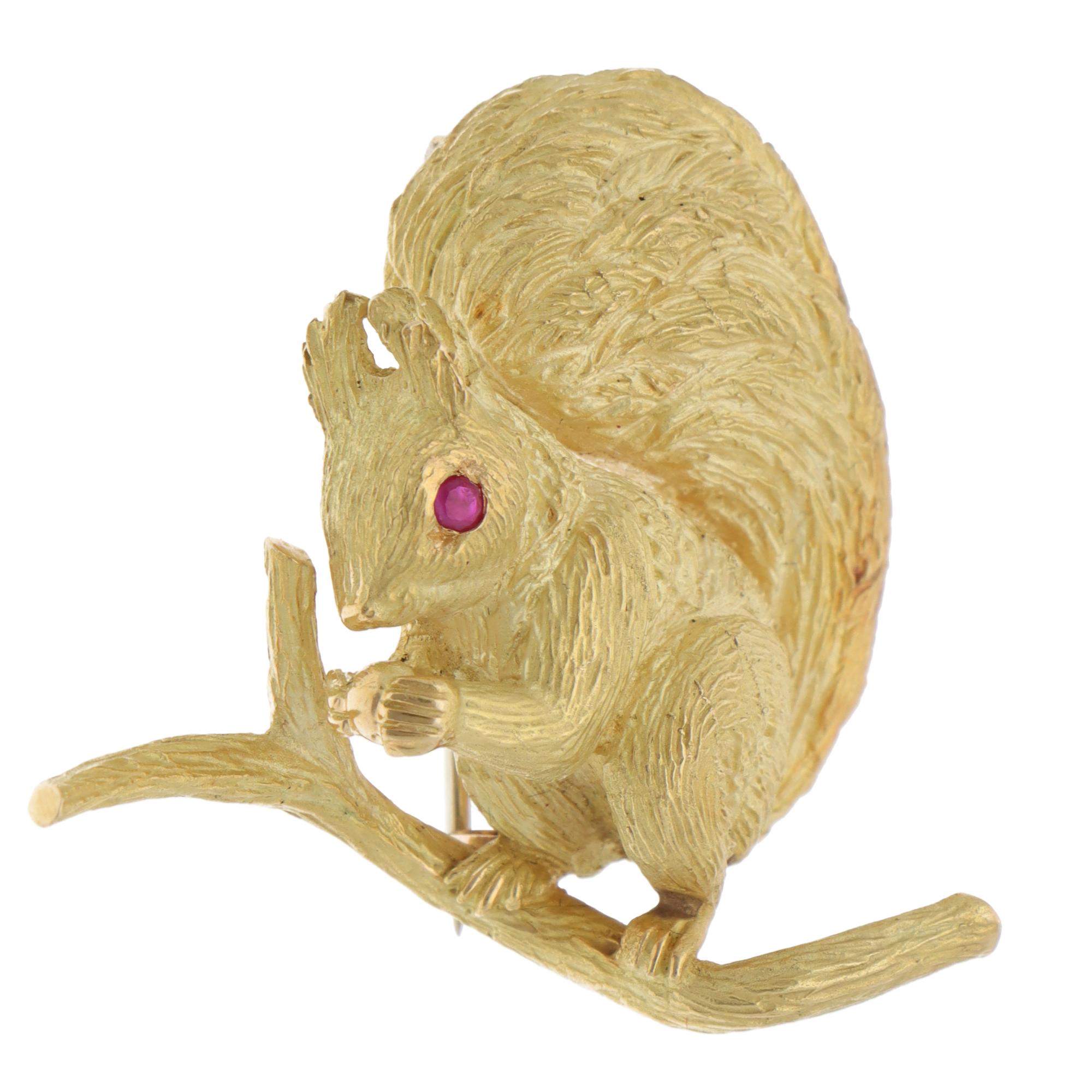 A beautiful vintage Hermès ruby squirrel brooch set in 18k yellow gold, circa 1960s.

The brooch depicts a perching squirrel motif and has been beautifully hand-crafted to show its naturalistic features. A mixed-cut ruby is bezel-set in polished