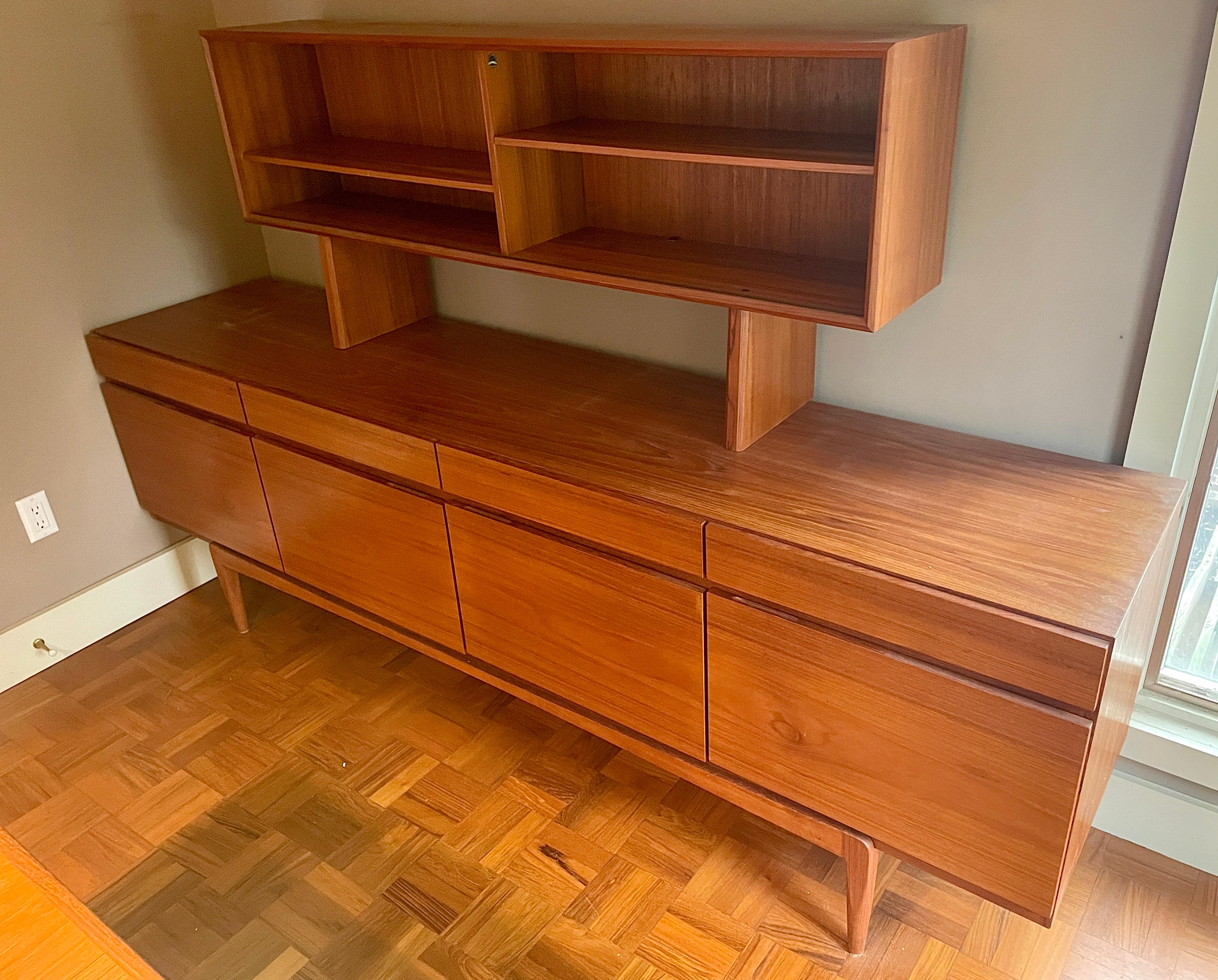 This piece is fully functional, a wonderful Danish high-end constructed cabinet, with 5 interior flatware drawers in the left cabinet bank, and an adjustable shelf behind the remaining three cabinet doors, and a matching teak finished back, for more
