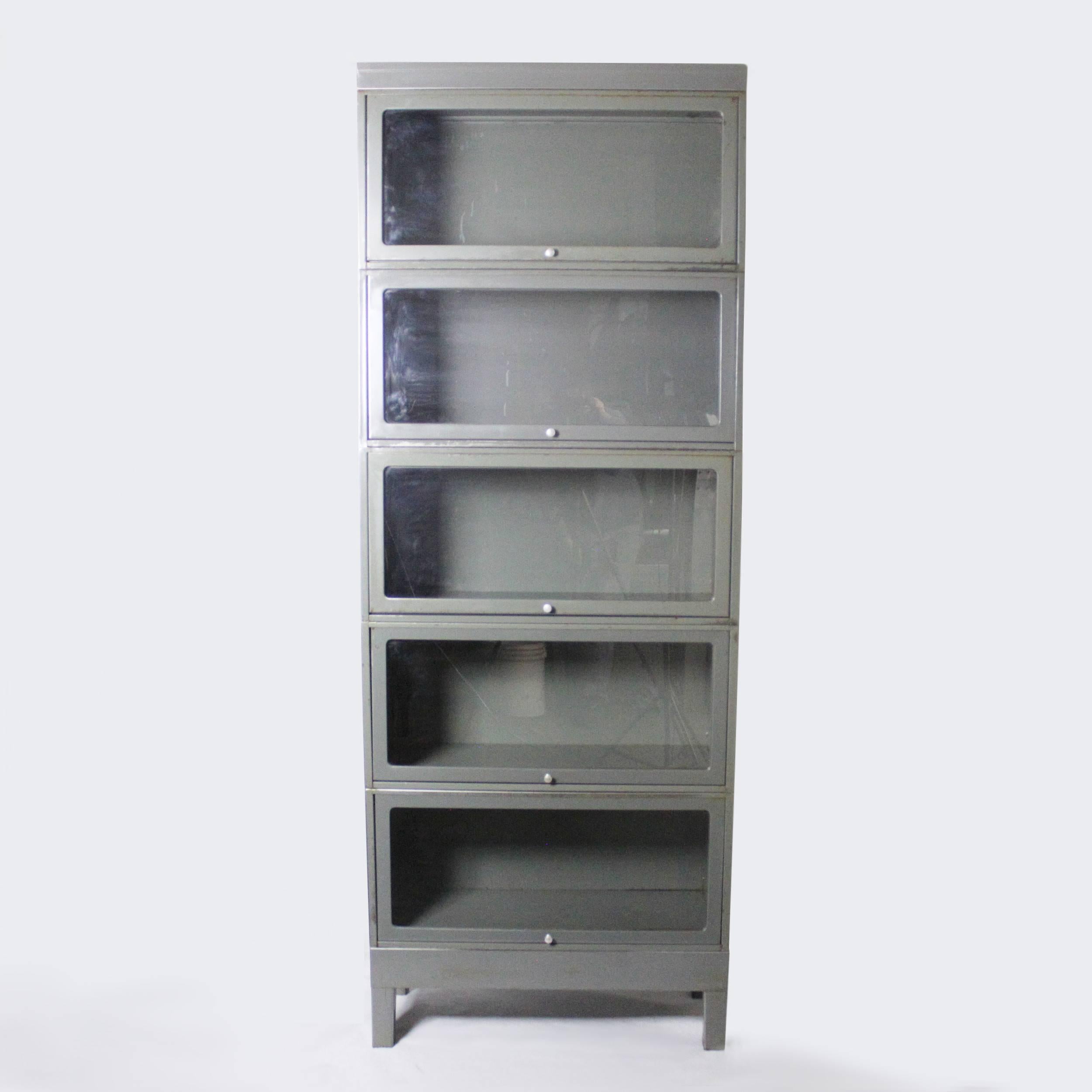 Fantastic vintage metal barrister bookcase. Bookcase stands over 7 feet tall and features a great Industrial patina to its original gray paint, steel construction, aluminium hardware, and clear, crack-free glass. Would add some impressive Industrial