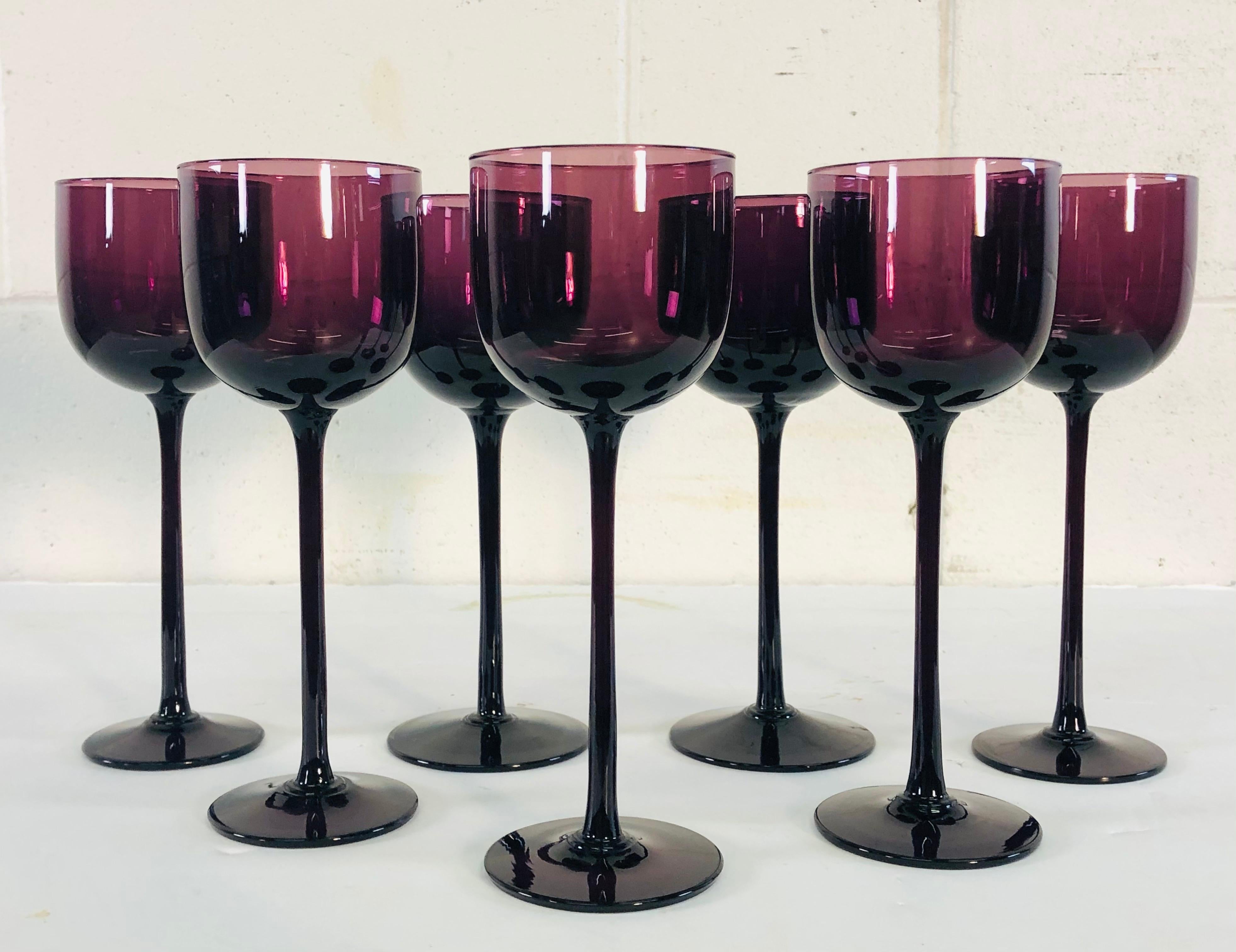 Vintage 1960s set of 7 tall hand blown Italian amethyst glass wine stems. No marks.