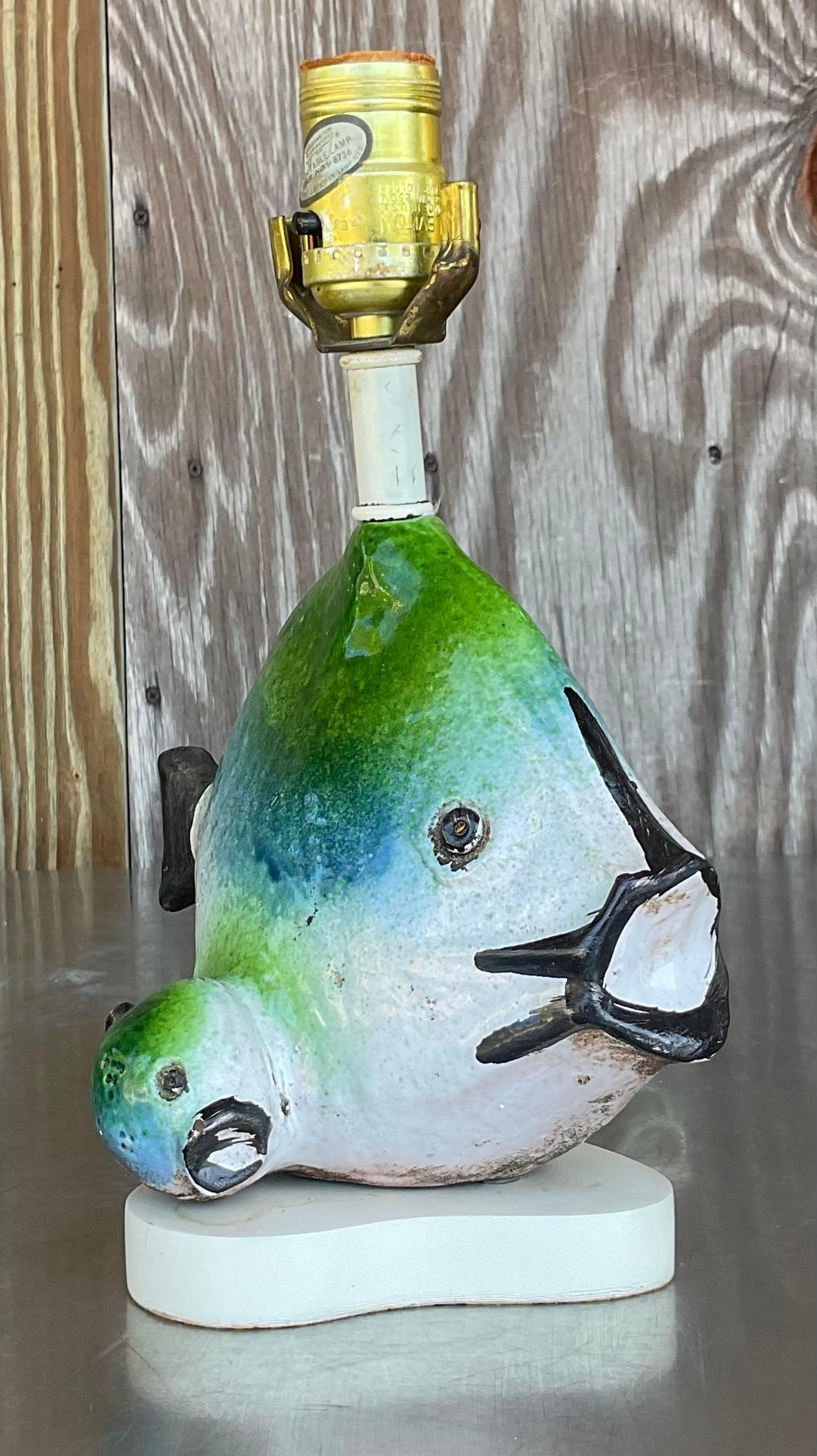 Illuminate your space with the whimsical charm of our Vintage 1960s Italian Gli Etruschi Fish Lamp. This iconic piece evokes the spirit of mid-century American design with its playful yet elegant fish motif. Crafted with exquisite detail, it adds a