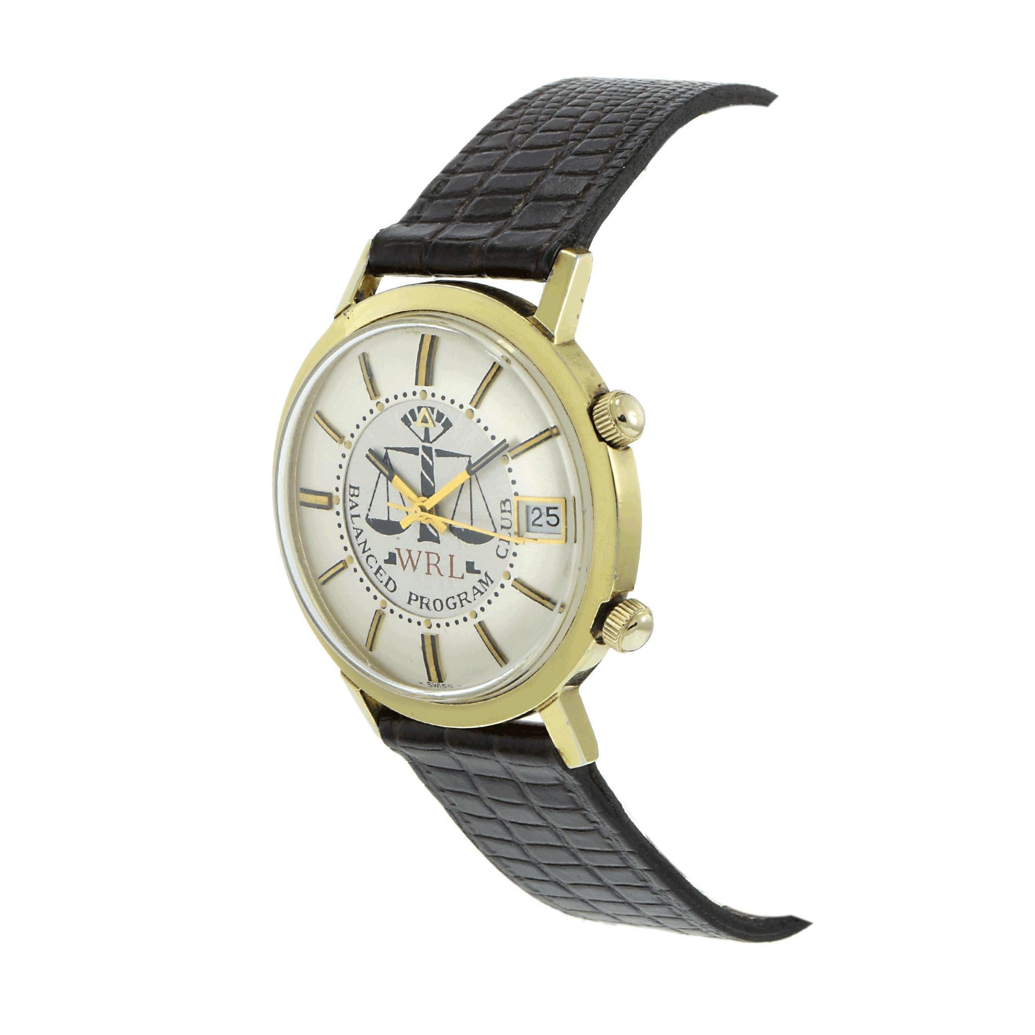 A distinguished 1960s Jaeger-LeCoultre Memovox Alarm watch, featuring a 37mm stainless steel case with 18K yellow gold plating. The silver dial is accented with raised gold markers, a date function, and a unique painted 