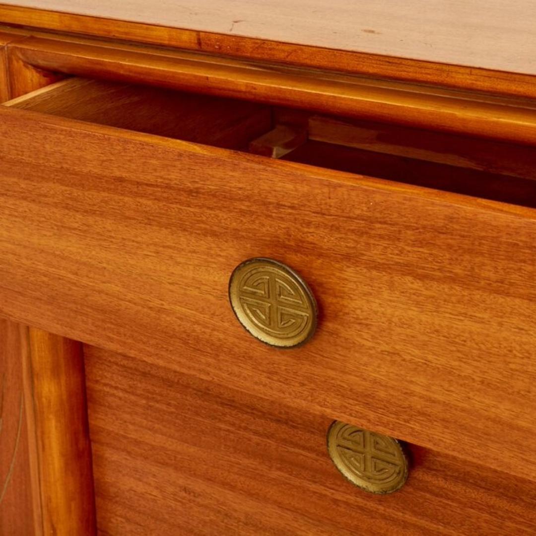 Inspired by Eastern design, this chic James Mont style credenza bridges Art Deco, Hollywood Regency, and Midcentury Modern aesthetics. Features chinoiserie hardware and intricate detailing. Four drawers offer ample storage. In excellent vintage