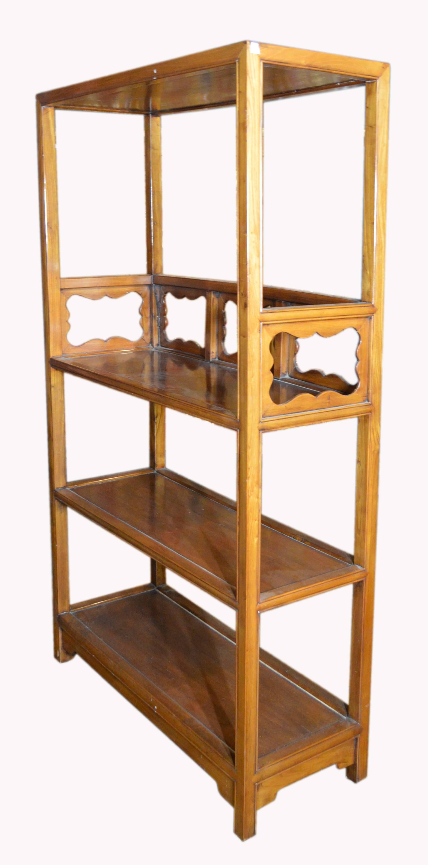 A vintage handmade Chinese lacquered yumu wood 1960s bookcase with hand-carved medallions. Made of yumu wood, this Chinese bookshelf features a nicely open linear silhouette, accented with three shelves. The upper shelf displays delicate hand-carved