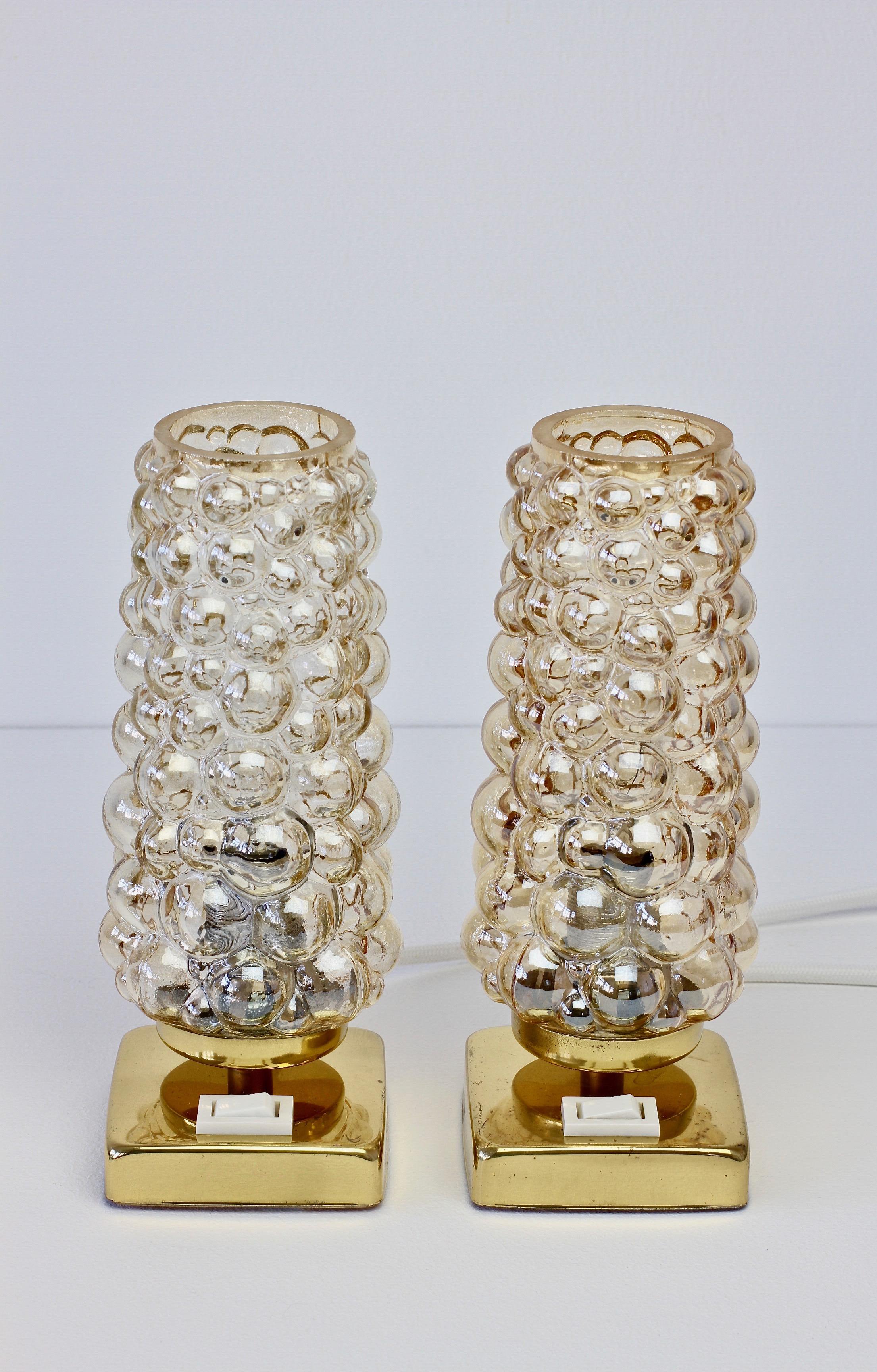 A pair of vintage midcentury amber bubble glass table lamps in the style of Glashütte Limburg by Teka Leuchten Germany, circa 1965. Featuring champagne colored/toned glass shades on brass bases - perfect on a pair of bedside tables or