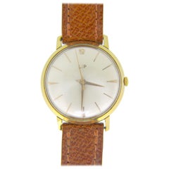 Montre à remontage manuel en or rose et jaune vif des années 1960