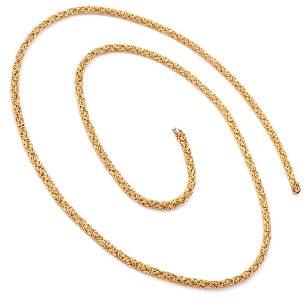 This stunning vintage long byzantine chain circa 1960’s with exquisite aesthetic and craftsmanship is rendered in solid 18K matted and artfully textured yellow gold. The necklace measures 42” long and 4mm in diameter, bears the purity mark '18K' and