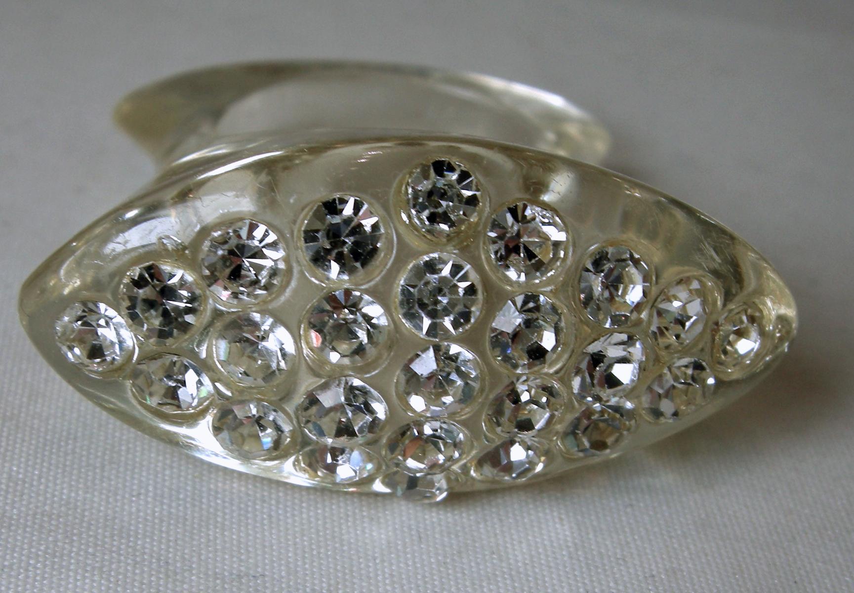 This vintage 1960s ring has beautiful clear crystals in a wide Lucite setting.  The ring is a size 8 and measures 1-1/4” x 5/8”.  It is in excellent condition.