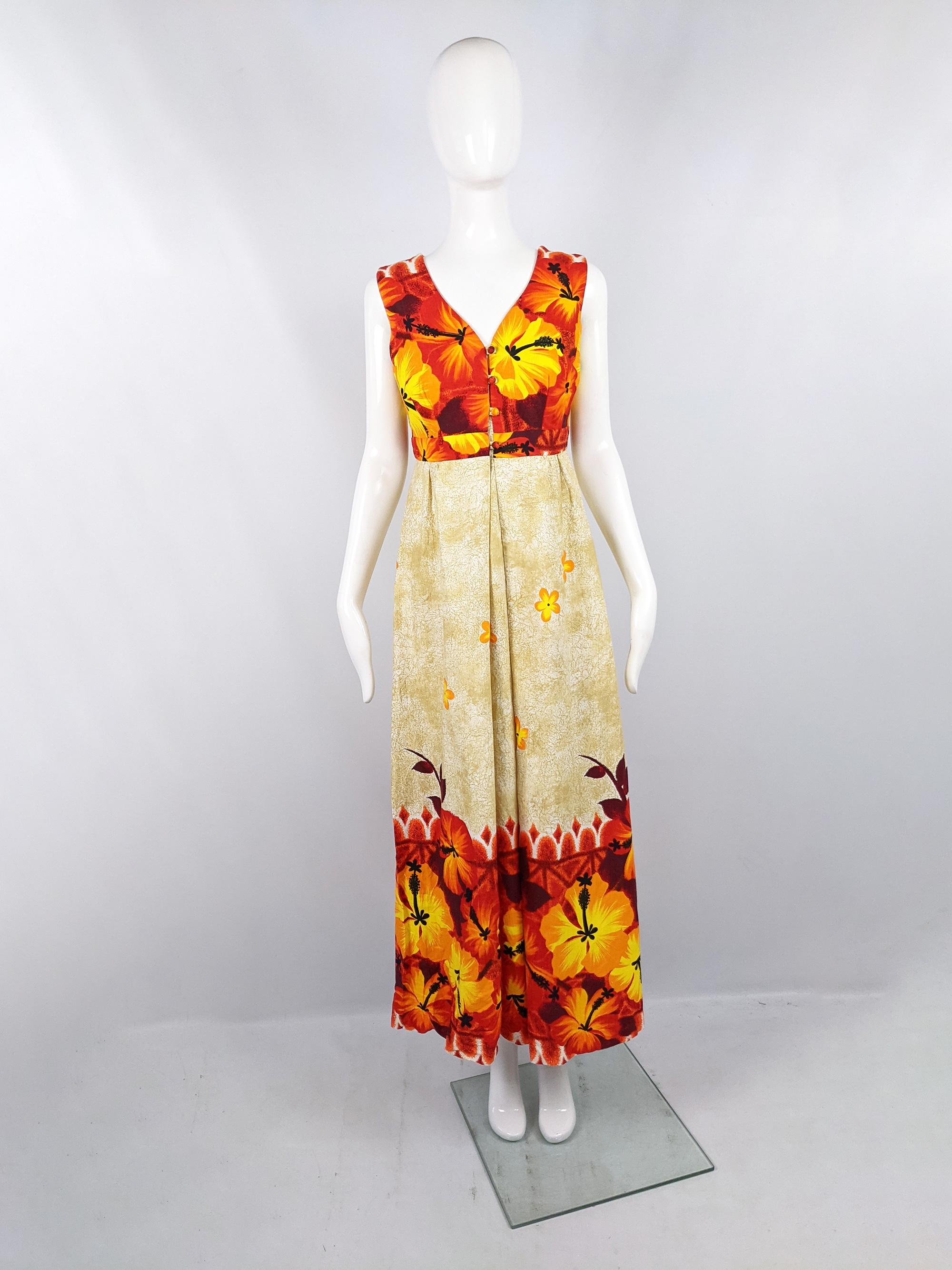 A stunning and rare vintage womens sleeveless maxi dress from the 60s by Hawaiian label, Island Casuals. In an orange, yellow and cream tropical cotton fabric with a deep v neckline. Perfect for a summer vacation.

Size: Marked vintage 12 but