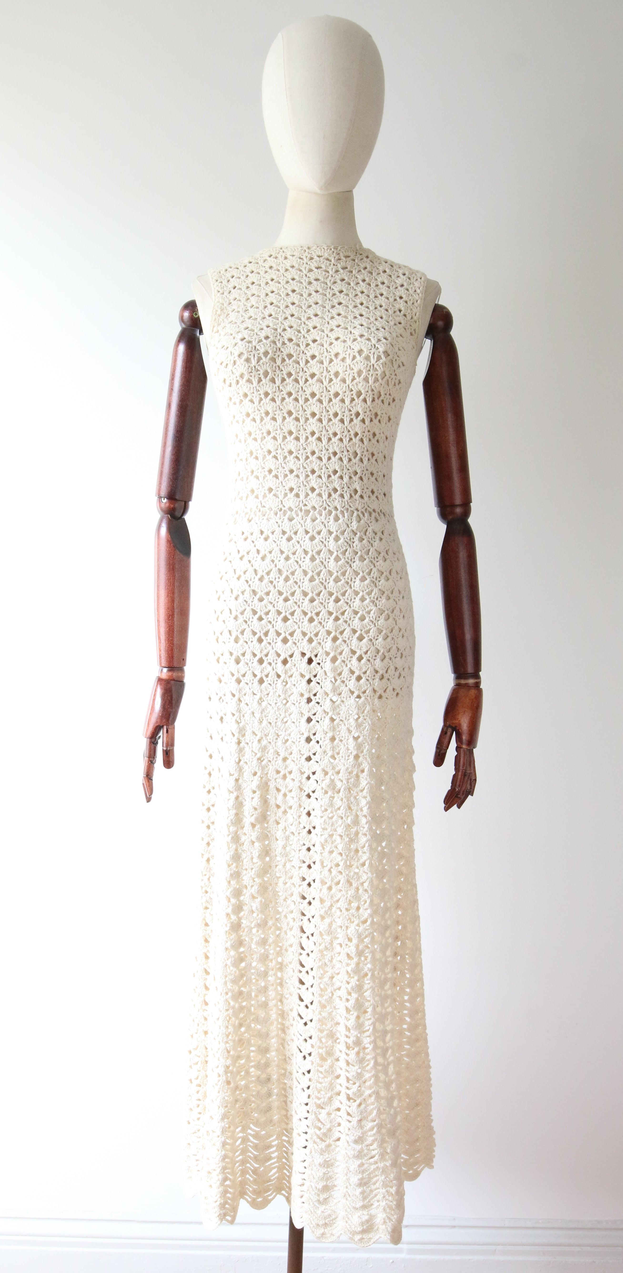Rendered in a wonderful cream crochet,  this original 1960's Mady Gerrard cream crochet dress and matching jacket is the perfect statement piece for your seasonal wardrobe.  

The rounded neckline of the dress is framed by a simple shoulder line and