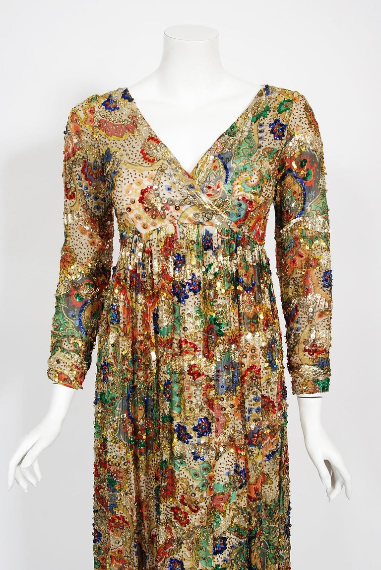 With the sparkling embellishment and metallic gold shimmer, this dazzling late 1960's Malcolm Starr evening maxi dress does not disappoint. The vibrant psychedelic paisley print netted metallic silk fabric is a treasure trove of color. I love the