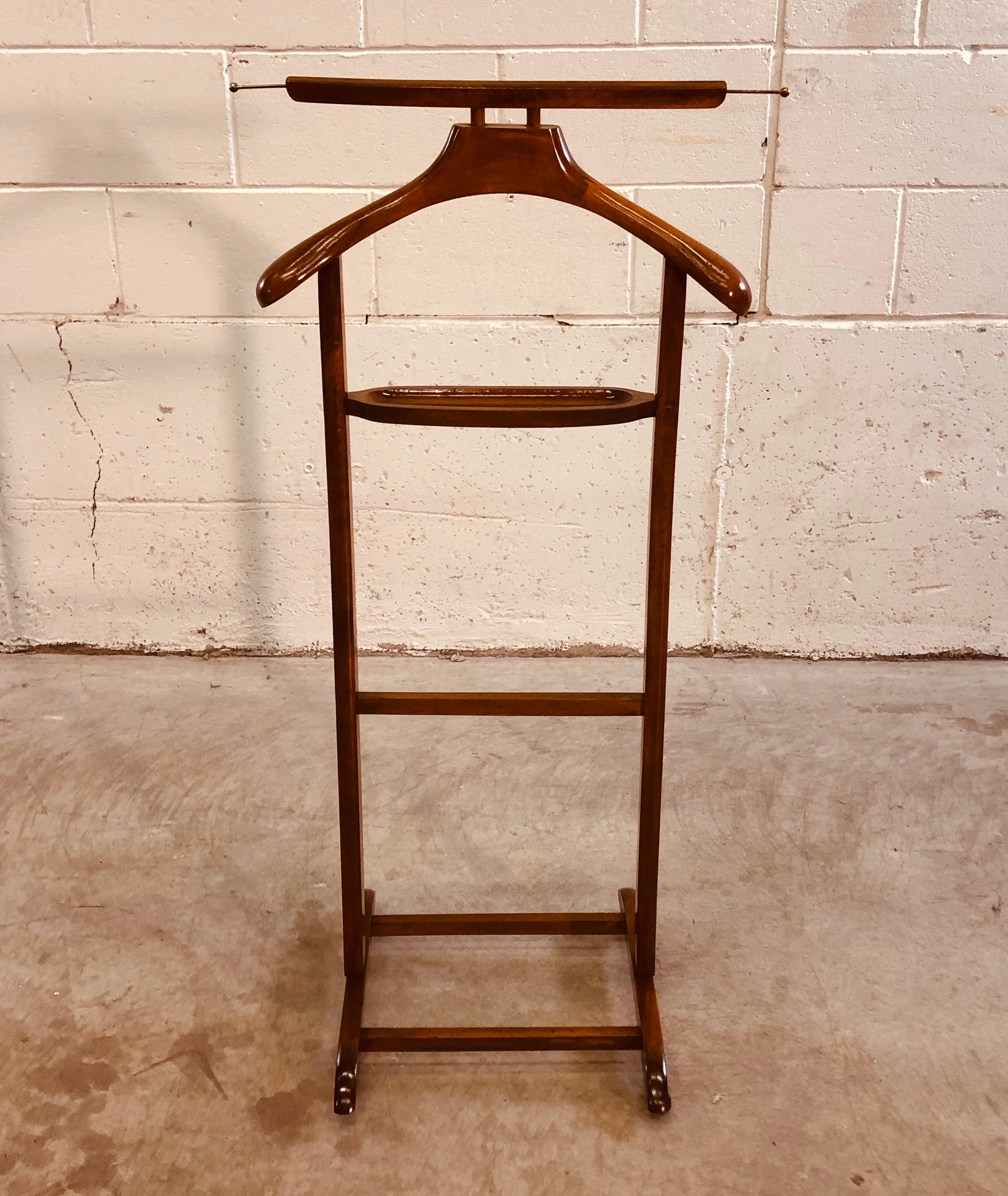Vintage 1960s maple wood bedroom valet stand on wheels. The wood is a dark maple wood and has been refinished. No marks. Excellent condition.