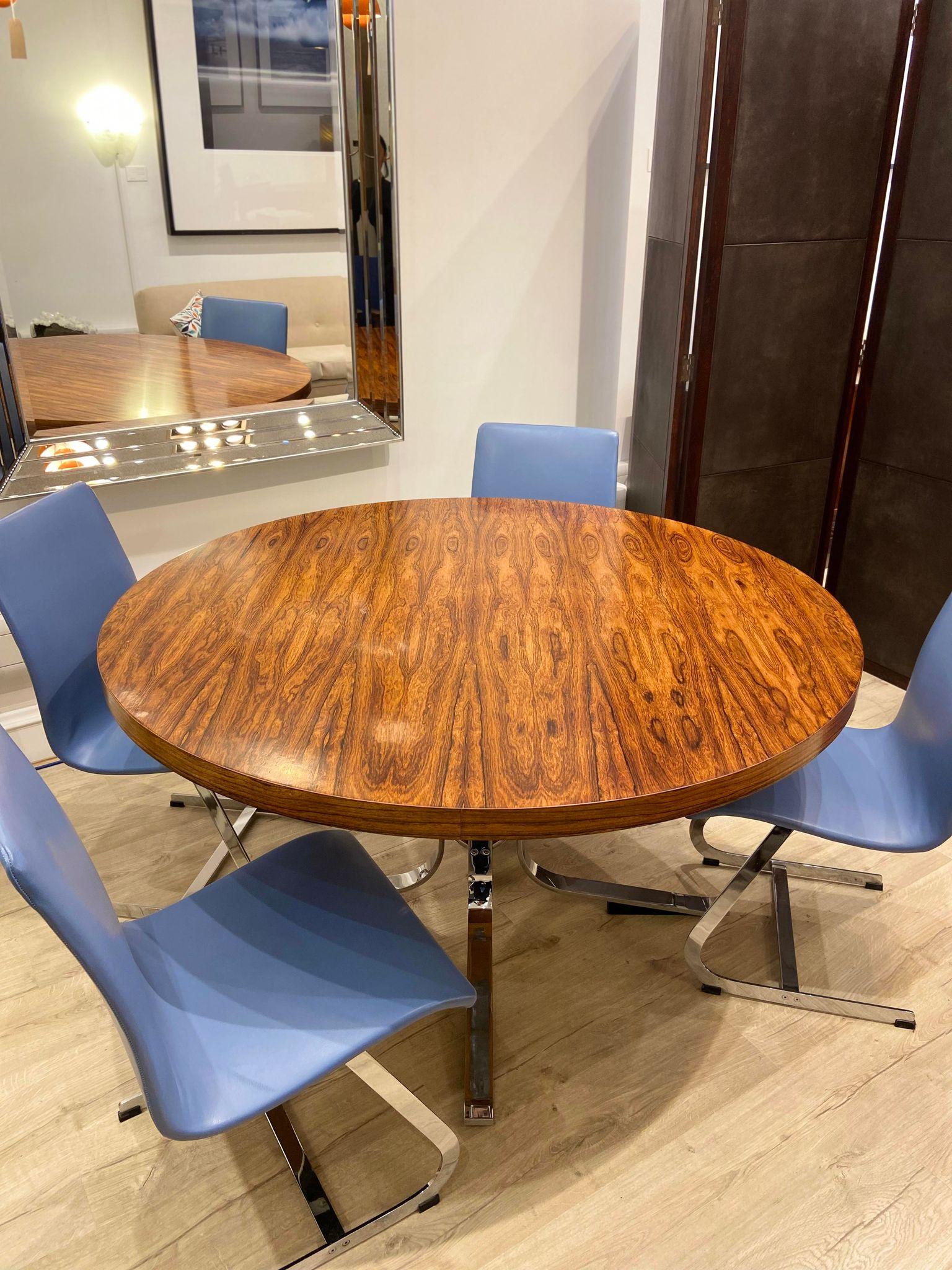 Vintage 1960's Rosewood Merrow Associates round dining table set on a chrome base. 

Dimensions:
Width: 137 cm
Height: 75 cm