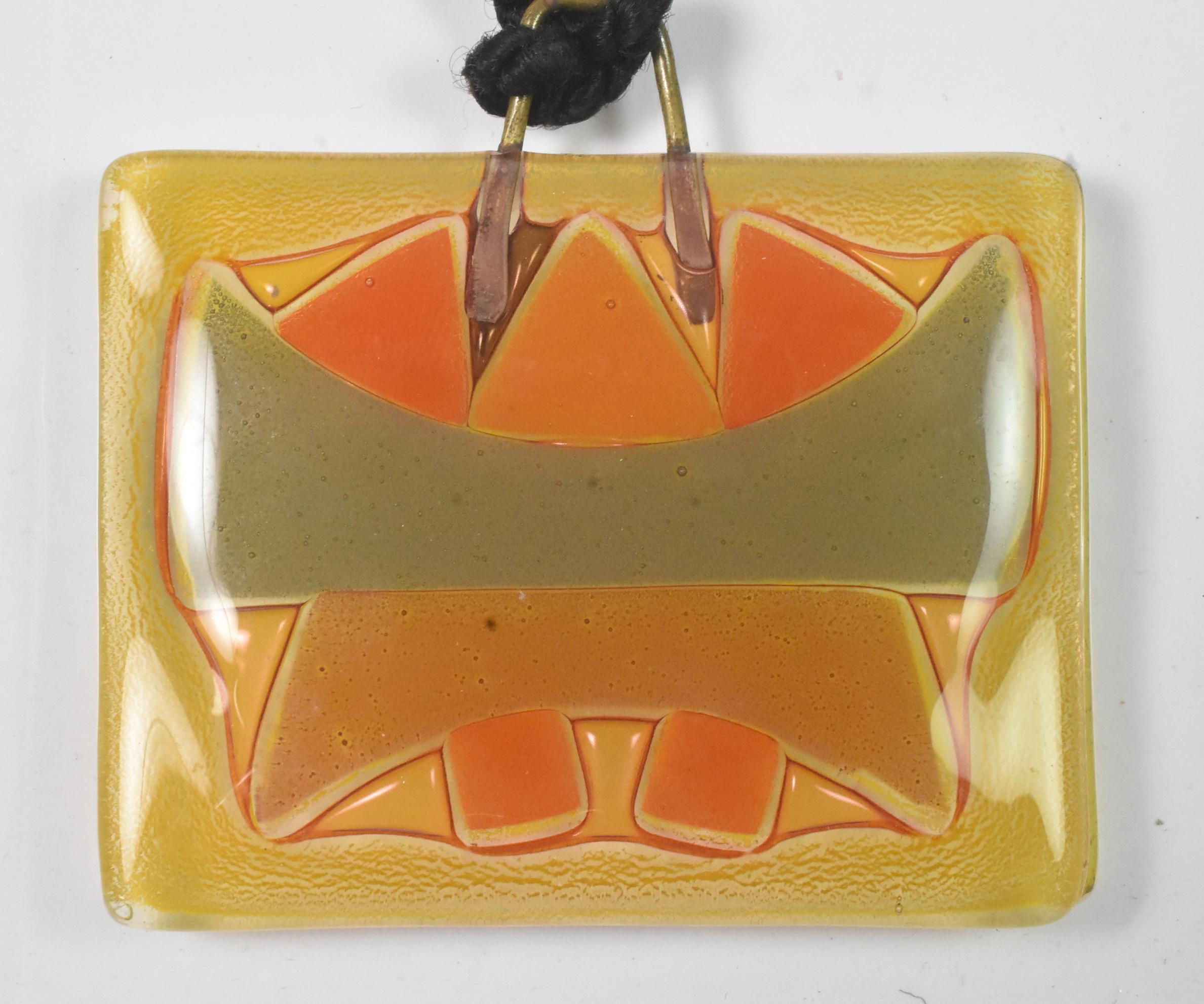 Vintage 1960s Michael & Frances Higgins American Modernist Fused Glass Pendant. Handmade glass pendant made up of yellow, orange, gold, and gray colors on a 25