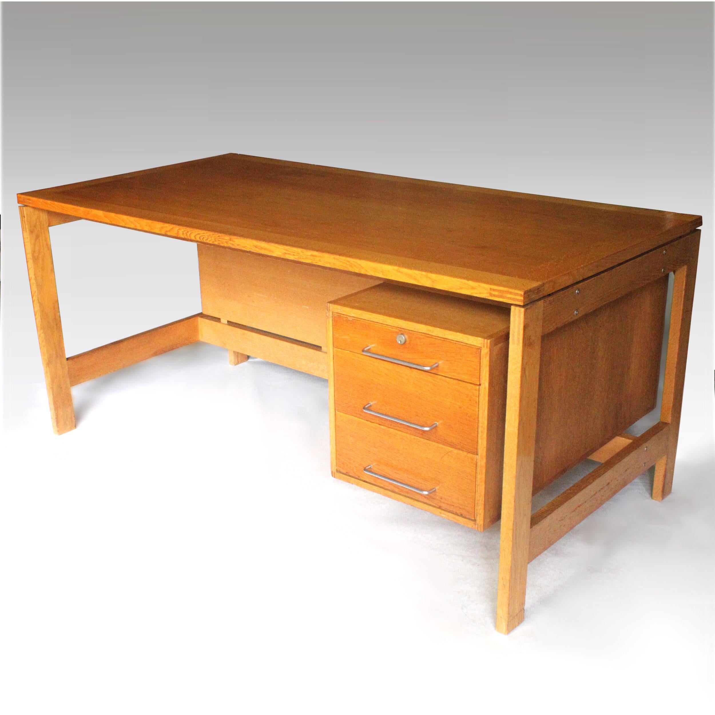 This is one great Dane! Designed by Henning Jensen & Torben Valeur for the furniture manufacturer Munch Møbler of Denmark, this desk is the epitome of Classic Danish design. Desk features solid oak construction with gorgeous exposed corner joinery,