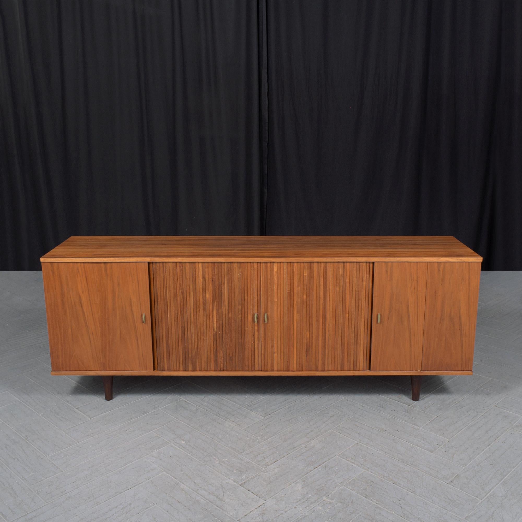 Discover the allure of mid-century design with our exceptional mid-century modern credenza, a striking piece from the 1960s that exemplifies the era's timeless design and expert craftsmanship. In great condition, this vintage server has been