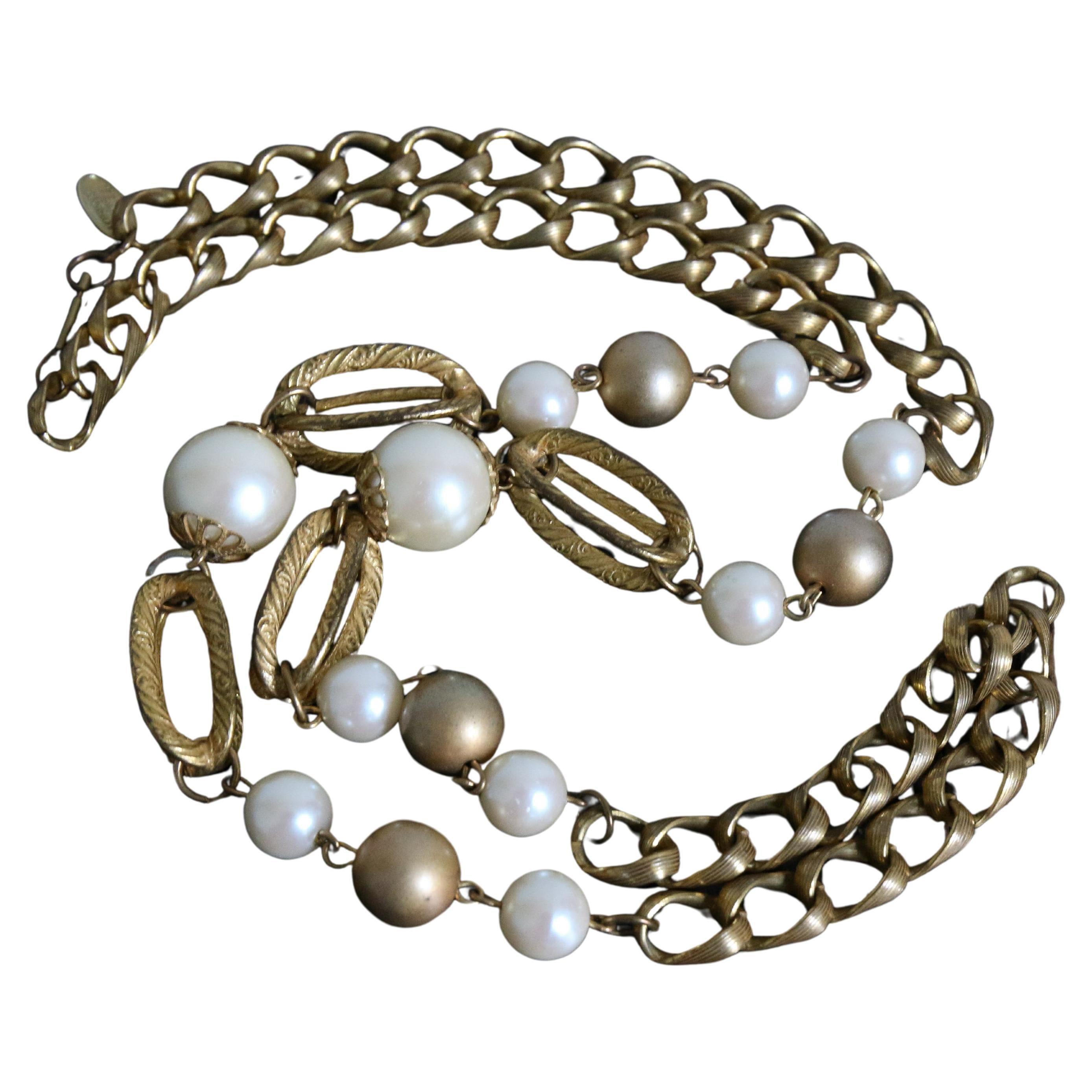 Diese atemberaubende und seltene Miriam Haskell-Halskette aus den 1960er Jahren besteht aus einem einzigen goldfarbenen Metallkettenstrang mit weiß und goldfarben schimmernden Perlen als Statement-Glieder, die dekorative, käfigartige, röhrenförmige