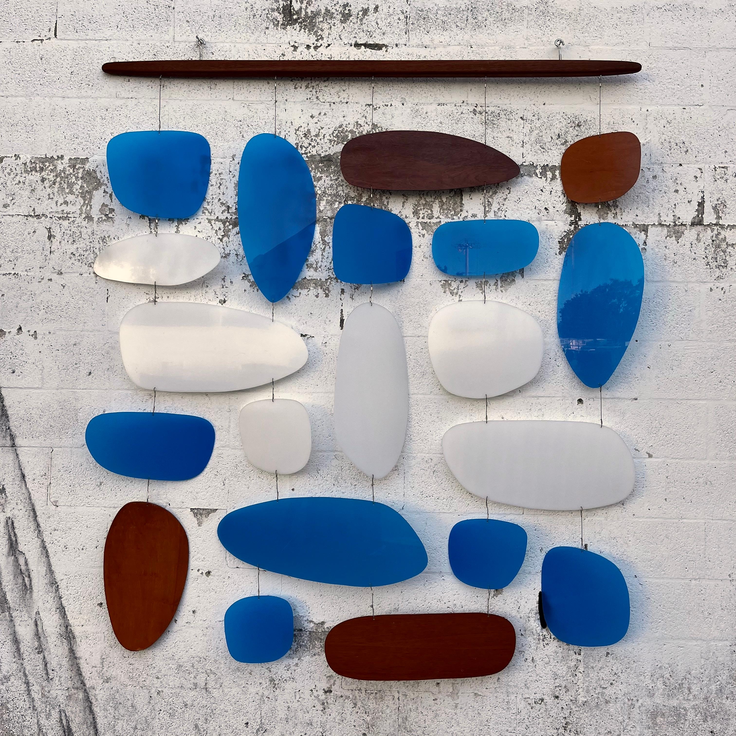 Vintage 1960s Modernist inspired handcrafted hanging wall sculpture / room divider by New Zealand Artist Andrew Reid. circa 1990s.
Features a combination of geometric shapes with rounded edges hand cut out translucent acrylic and plywood, connected