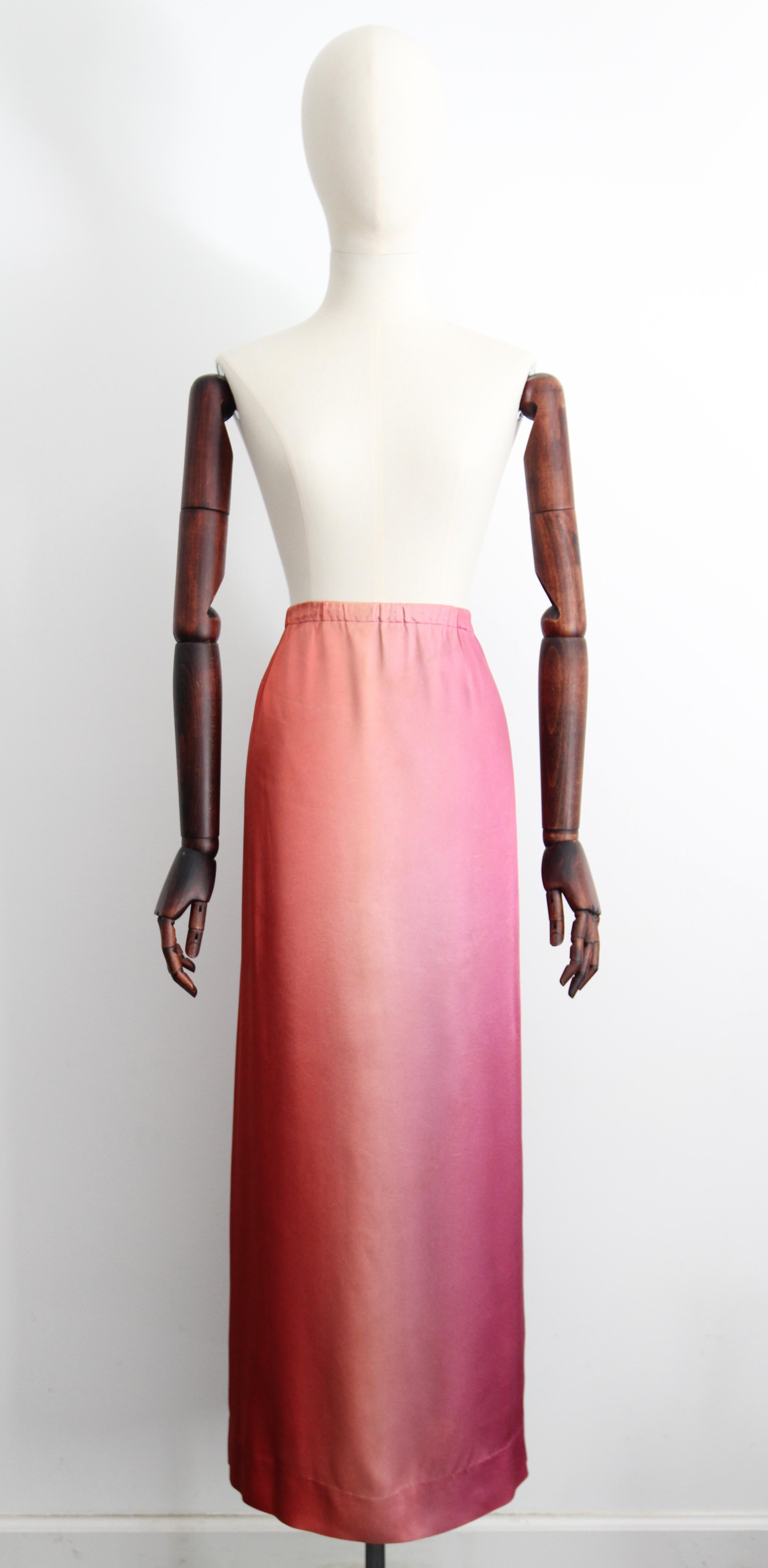 Rendered in the most sumptuous ombré satin, in a sunset palette of terracotta, coral and peach, which blend into soft pinks and into fuschia, this iconic 1960's ensemble, composed of a tunic and longline skirt, is the perfect set to add to your