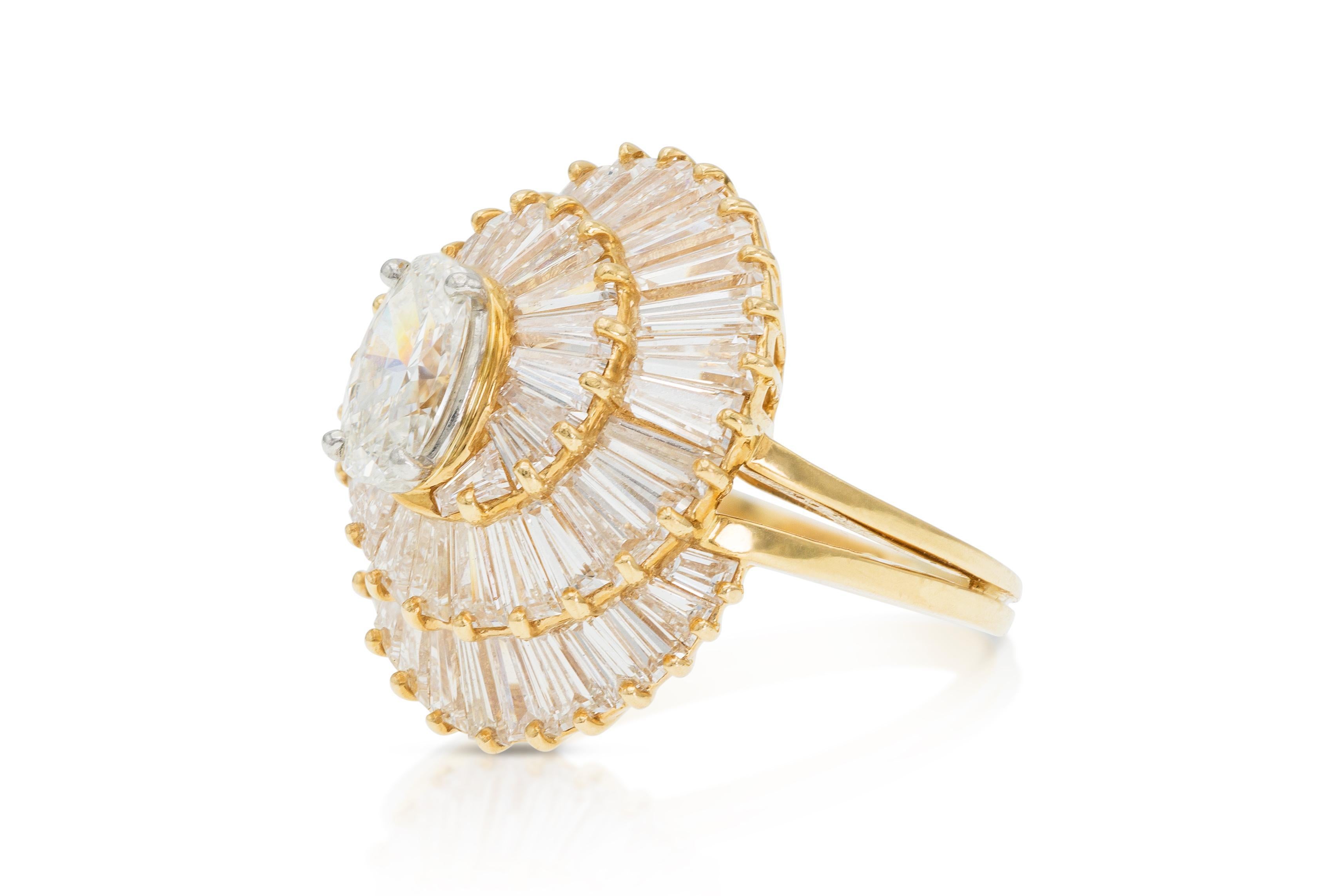 Finely crafted in 18k yellow gold with an Oval cut center Diamond weighing 0.80 carats, and Tapered Baguette cut Diamonds weighing a total of 4.16 carats.
Signed by Oscar Heyman
Crca 1960s
Size 4, resizable