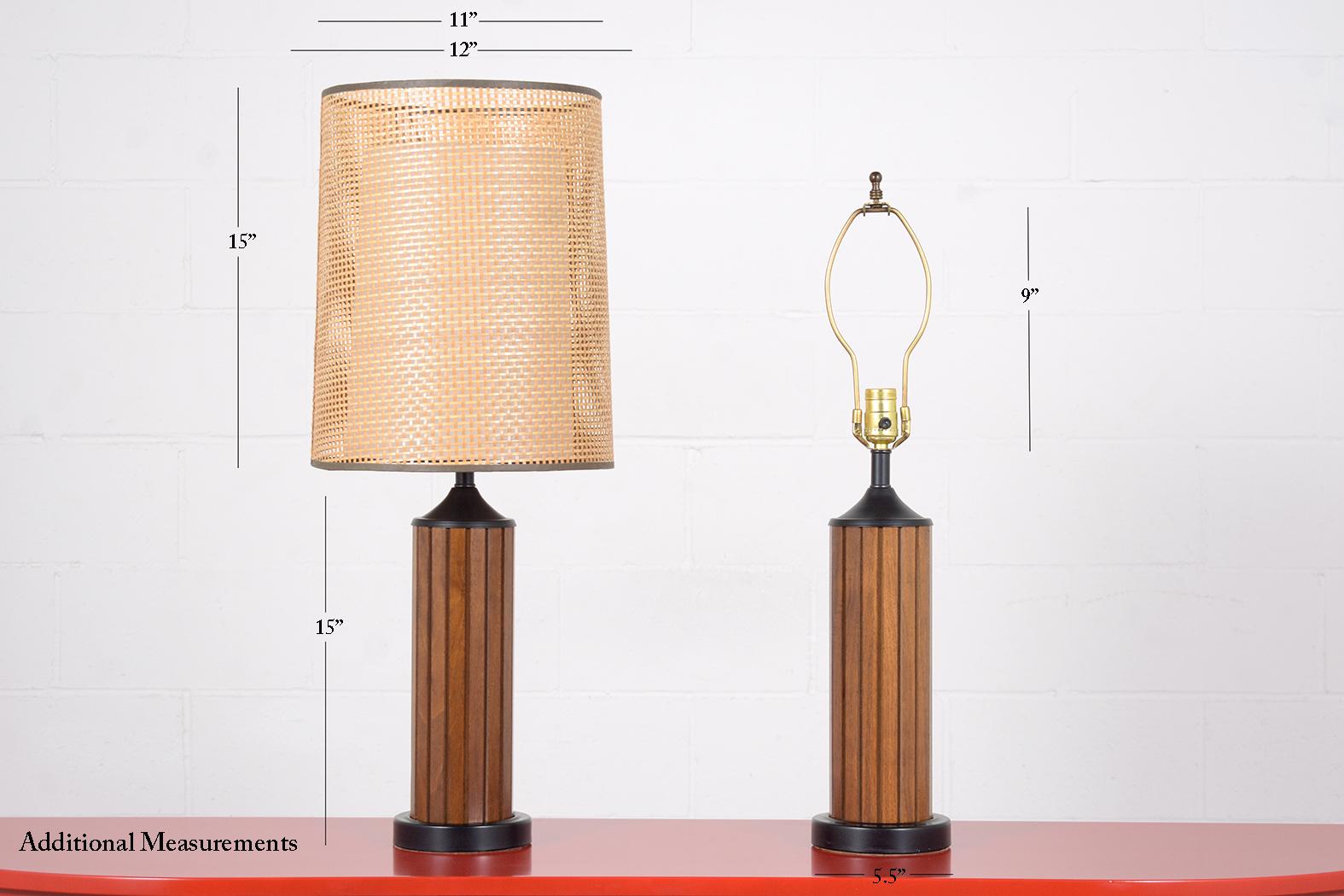 An extraordinary pair of mid-century table lamps executed out of wood and are in great condition newly refinished and wired by our expert craftsman team in-house. This pair of sleek table lamps features intricated round shades made out of cane
