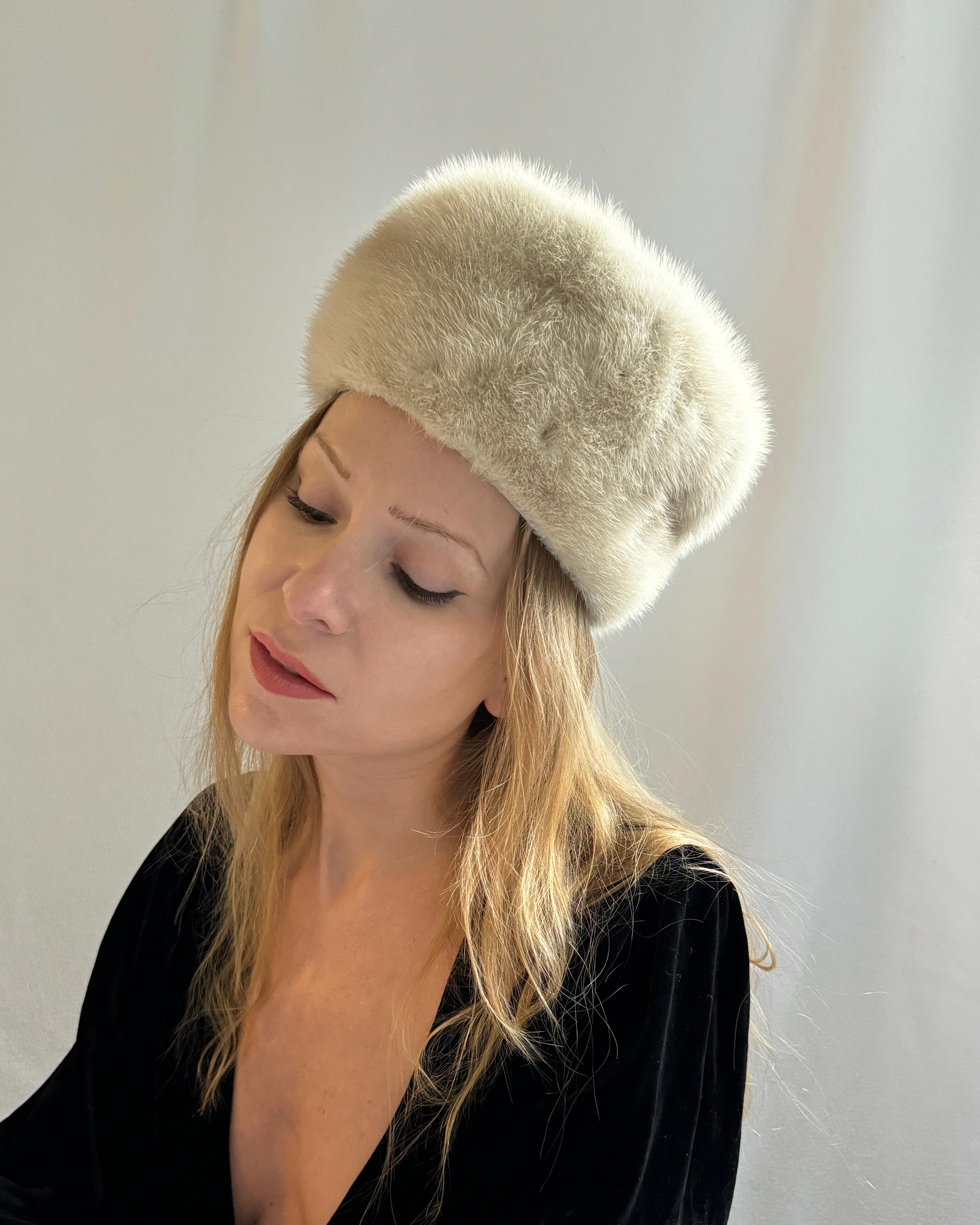 This vintage 1960s mink cossack hat is the most gorgeous golden pearl color that looks good on everyone. The fur has some natural variations to the color which add depth to its richness. It is so soft and so warm, yet because of the natural fibers,