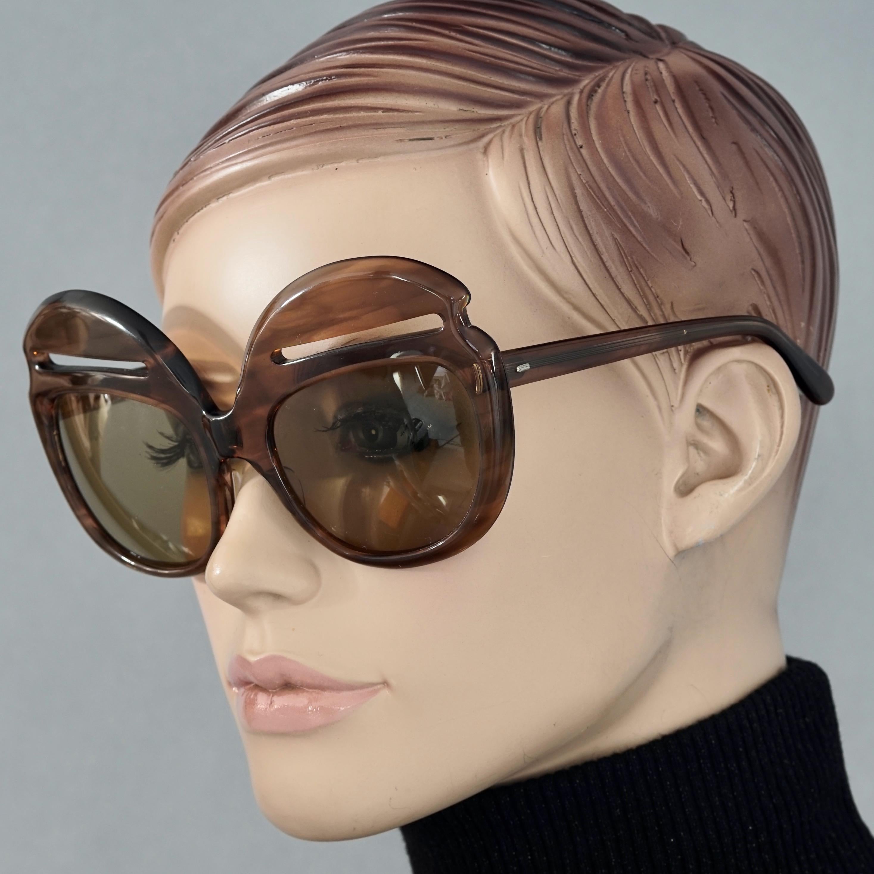 Vintage 1960s PIERRE CARDIN Iconic Oversized Eyebrow Sunglasses

Measurements:
Frame Height: 3.07 inches (7.8 cm)
Frame Width: 5.90 inches (15 cm)
Arms: 5.11 inches (13 cm)

Features:
- 100% Authentic PIERRE CARDIN. 
- Brown oversized sunglasses
