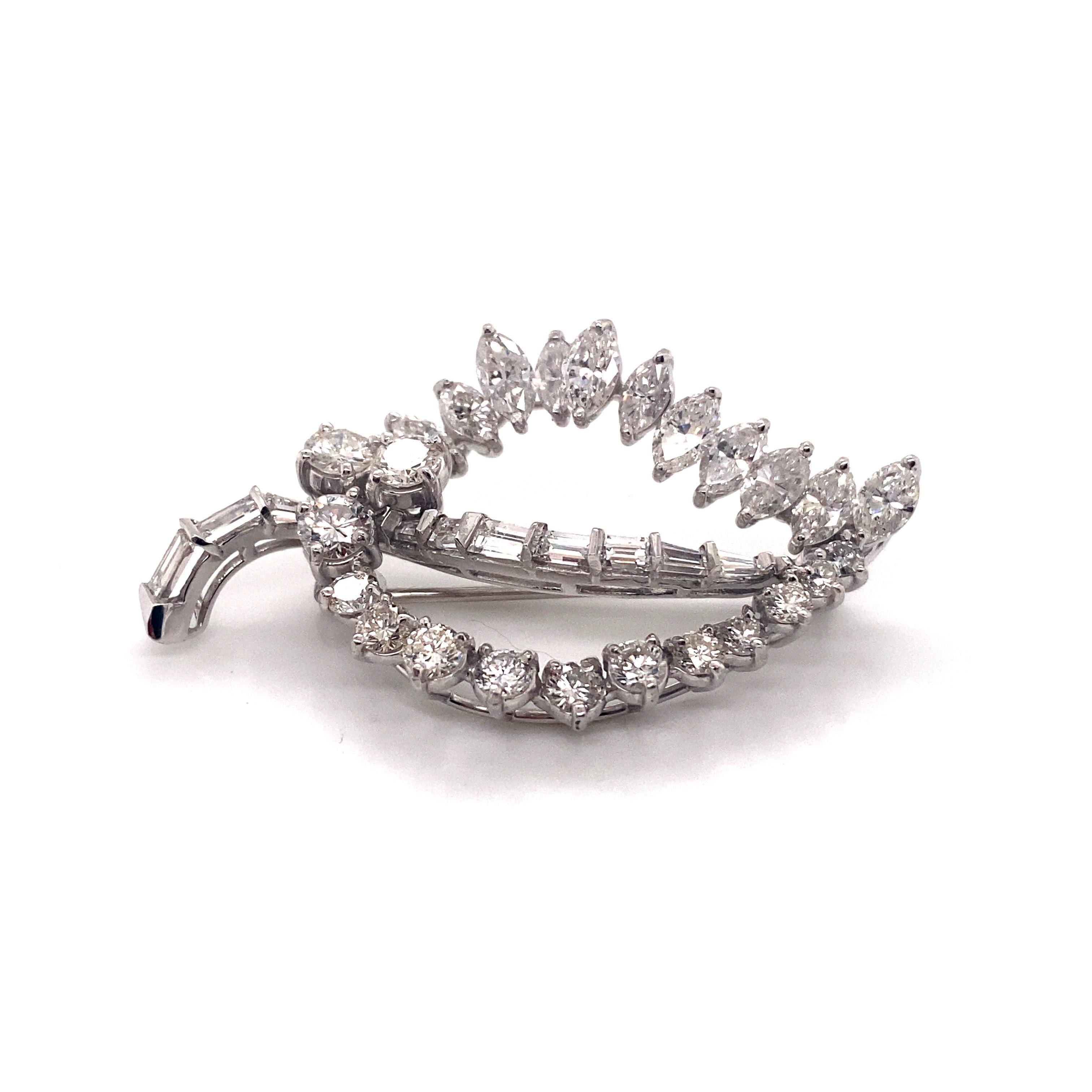 An extraordinary display of 1960s jewelry artistry, this vintage platinum leaf brooch dazzles with nearly 5 carats of brilliant diamonds. The sculptural design features a dimensional leaf motif set with a gorgeous array of diamond shapes. Forming