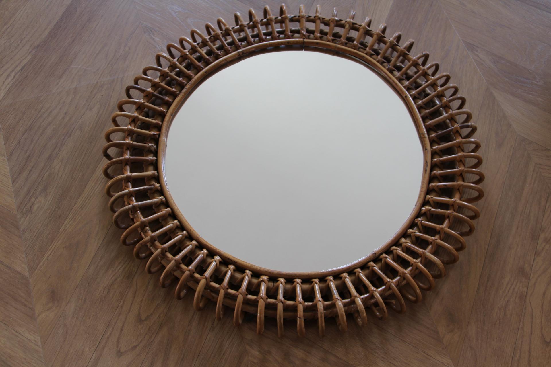 This very decorative mirror was made in Italy in 1960s. It is typical of this period design and is all original. It was handcrafted and is in perfect condition. It has got a beautiful round shape. 
It could be put on a wall on its own or mixed with