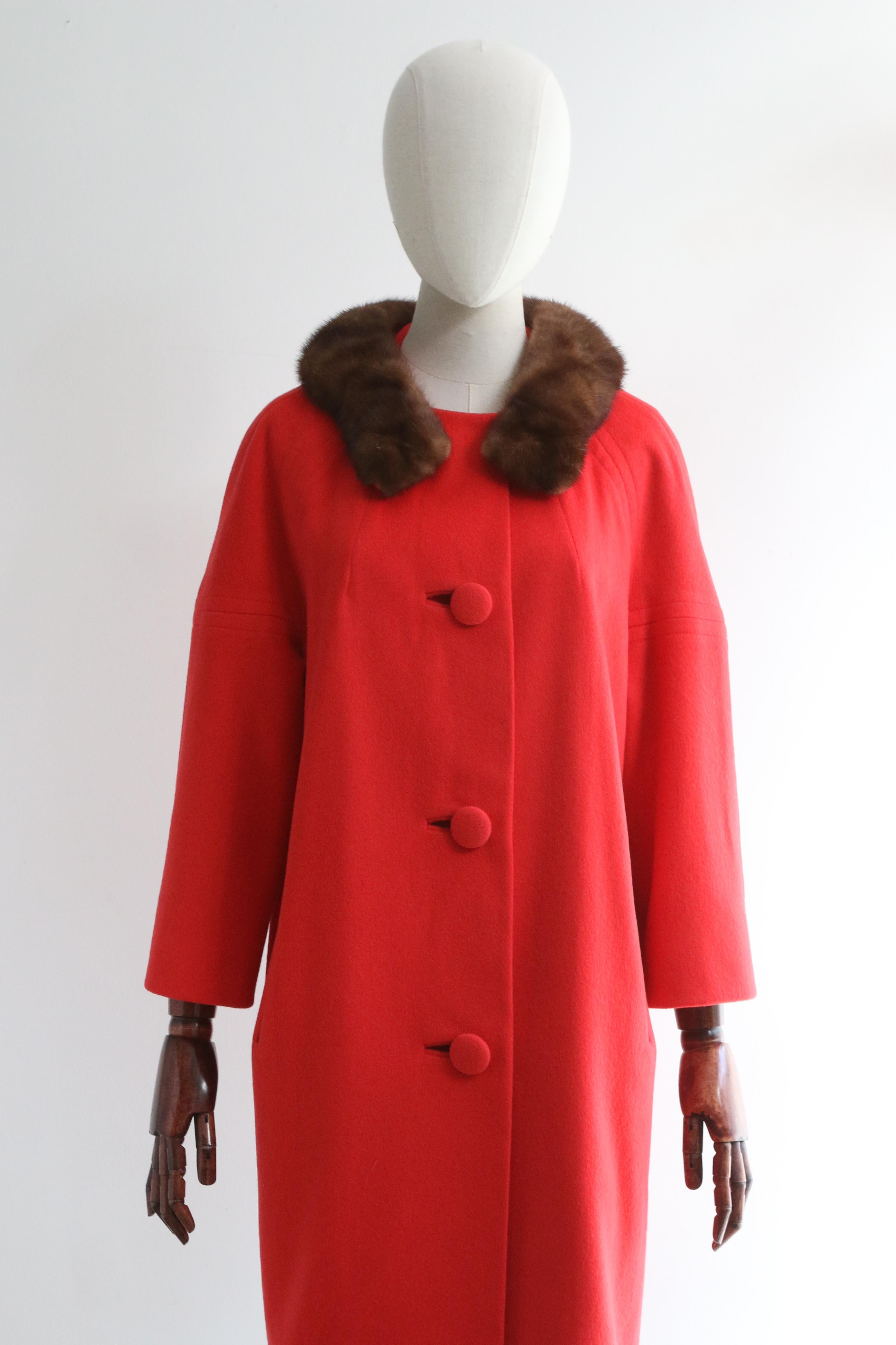 This wonderfully bright 1960's Lilli Ann coat in a vibrant shade of big apple red wool, finished with a chocolate brown mink fur collar, is the perfect piece to welcome the new season with.

The rounded neckline is framed by an elegant brown mink