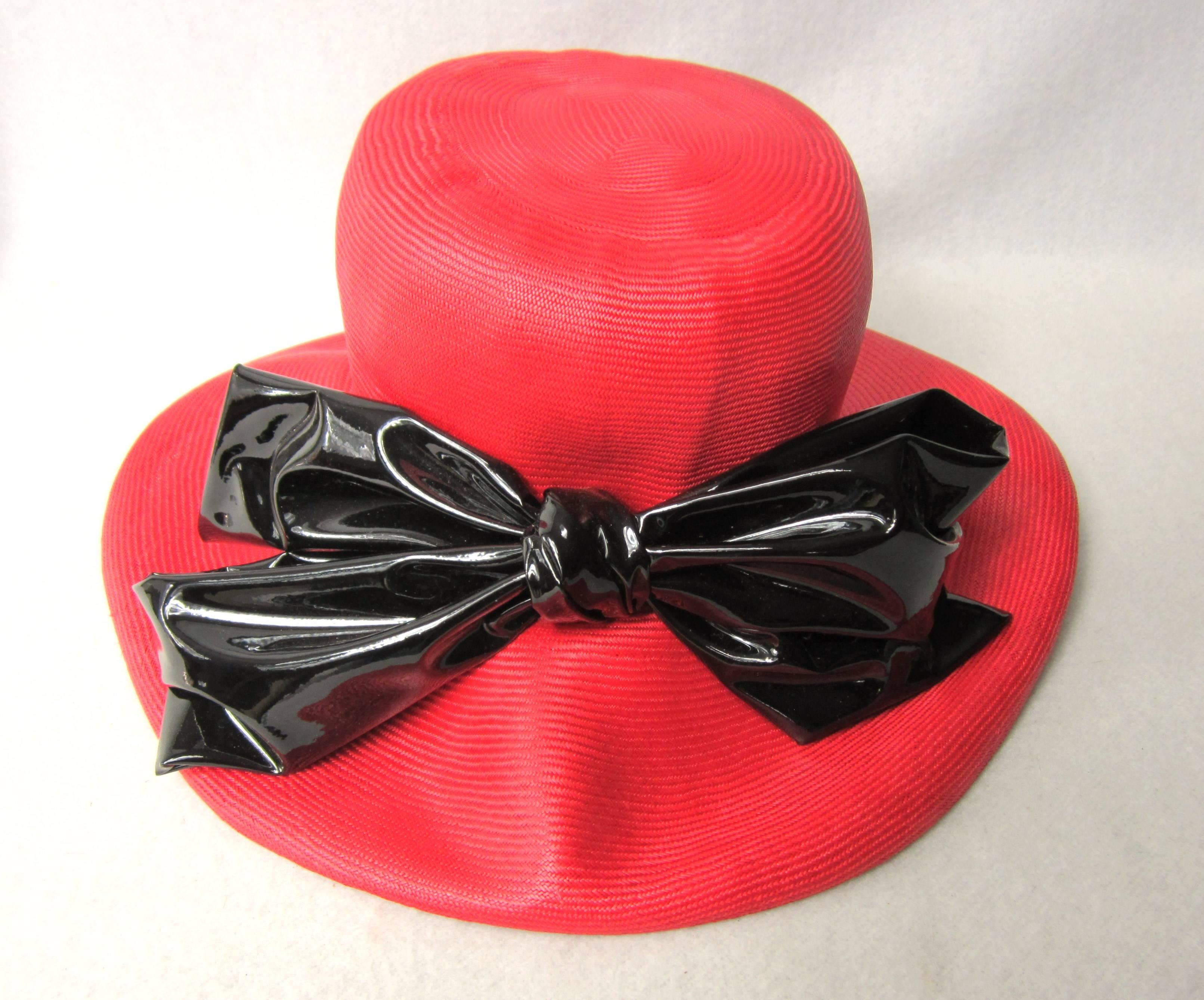 Large Crown with an Oversized Black Patent Bow. The brim is flexible. 23 in measured around the inside Brim Approx. 7-1/4. The bow is 11in wide- Brim is 4 inches. We have hundreds of New Never Worn items on our storefront. Be sure to check our store
