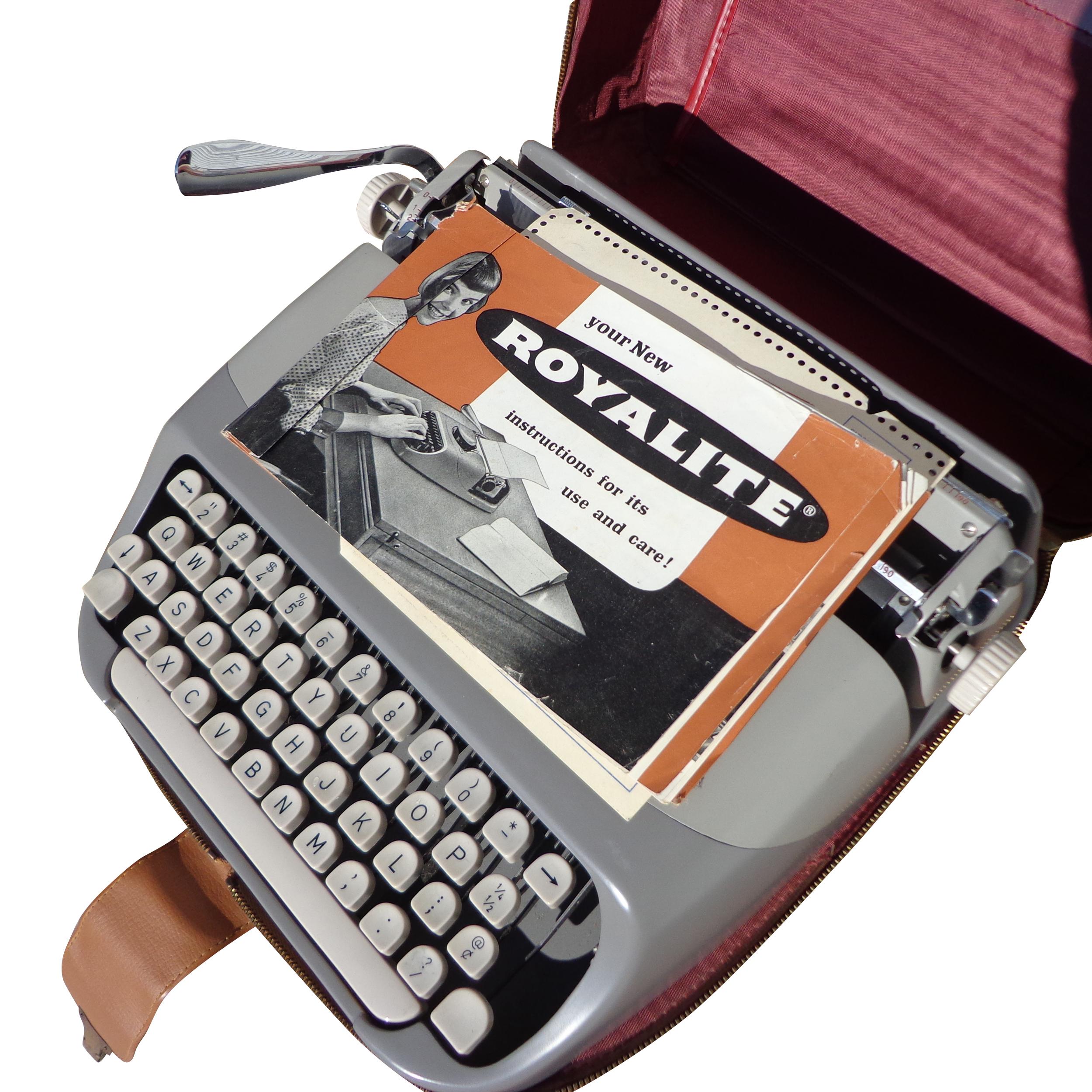 1960s Royal Holland Royalite Portable Typewriter and Case

Includes the original carrying case and owner manual. 

New typewriter ribbon suggested.