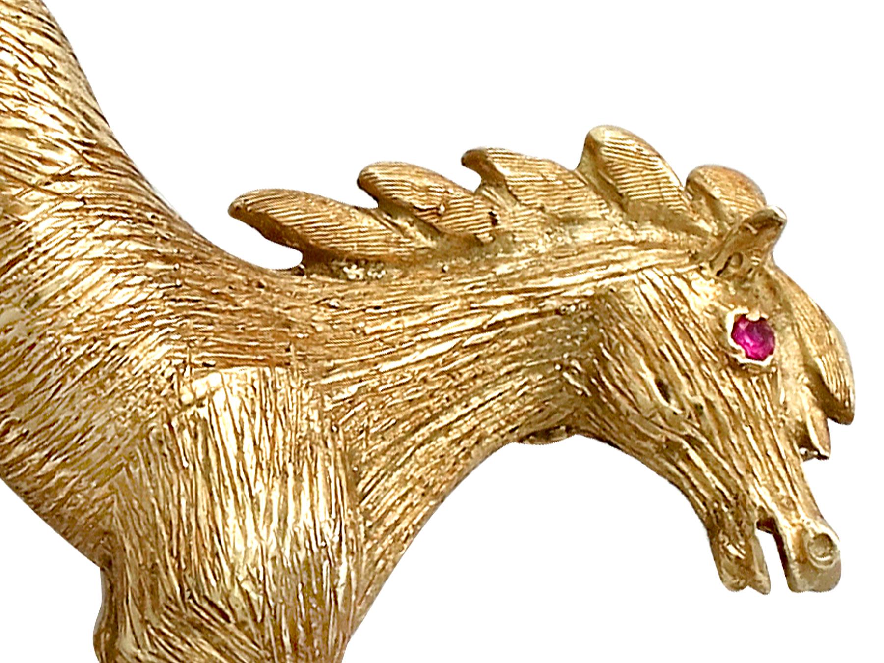 An exceptional, fine and impressive vintage 0.02 carat natural ruby and 18 karat yellow gold brooch modelled in the form of a galloping horse; part of our vintage jewelry and estate jewelry collections

This exceptional, fine and impressive vintage