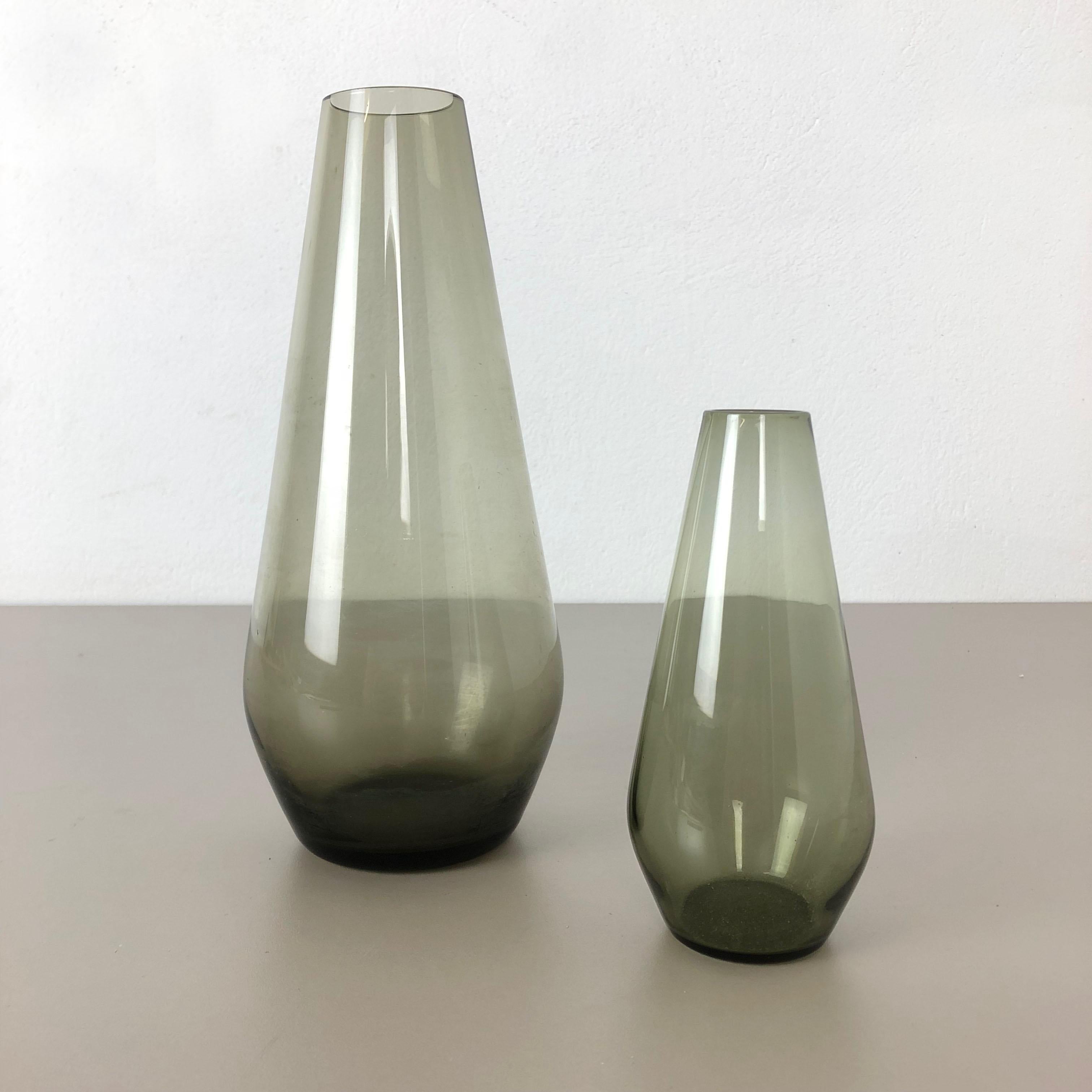 Article:

Set of 2 tourmaline vases


Producer:

WMF, Germany


Design:

Prof. Wilhelm Wagenfeld Bauhaus 



Decade:

1960s


Description:

Original vintage 1960s Set of 2 vases of the Wagenfeld tourmaline series. These two vase are designed by