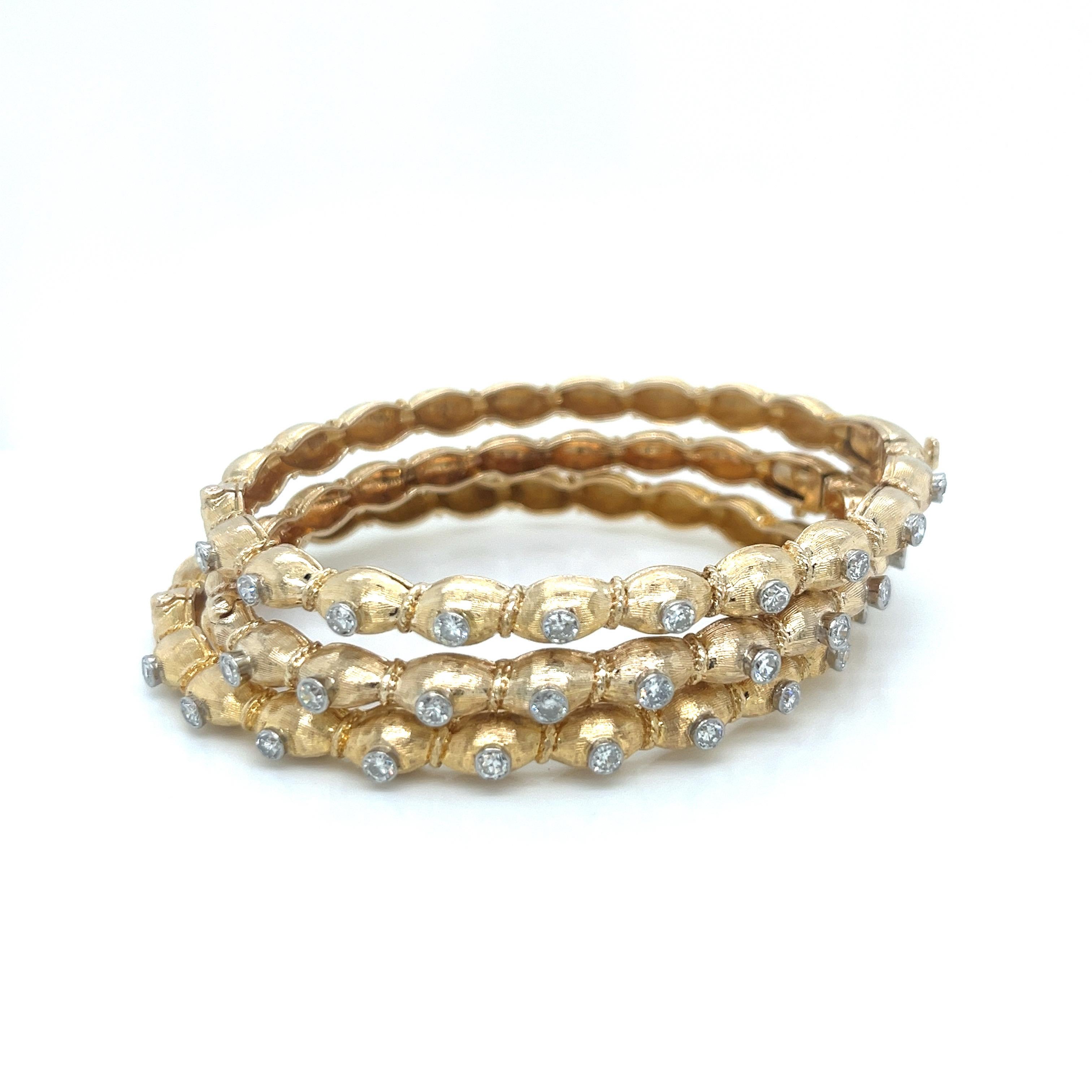 Vintage 1960's Set of 3 14K Yellow Gold Diamond Bangles

This exquisite trio of vintage bangles showcases the timeless elegance of 1960's jewelry craftsmanship. Each bangle is meticulously crafted in 14K yellow gold with a sophisticated 5.6mm width