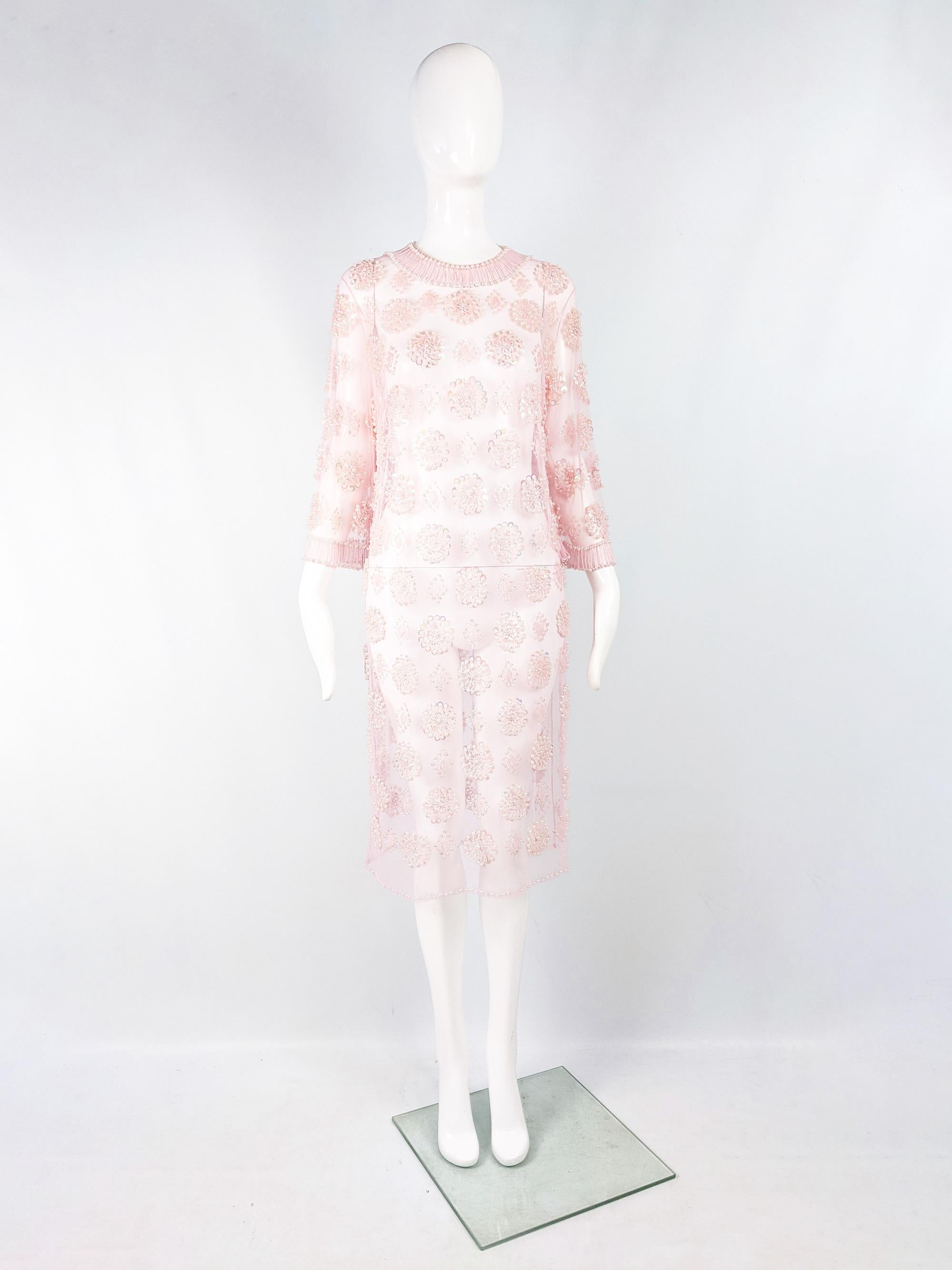 An amazing vintage womens dress from the 60s in a completely sheer, beaded and sequinned delicate mesh fabric which makes it so versatile, allowing for a slip, contrasting dress or bra and shorts to be worn underneath. It has a slightly wide sleeve