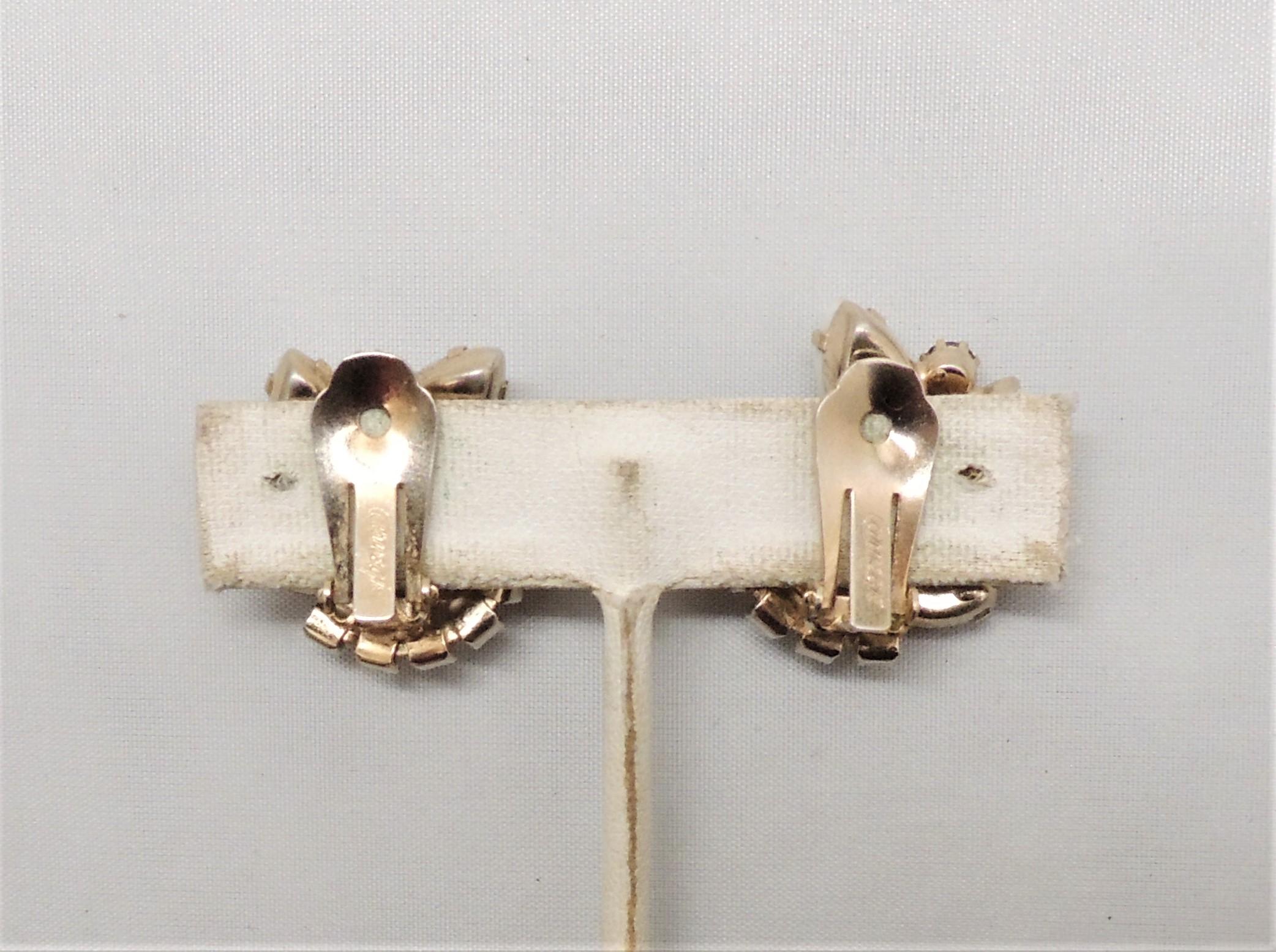 1960s goldtone prong set round and marquise faux-topaz with marquise art glass accents clip back earrings.  Marked 