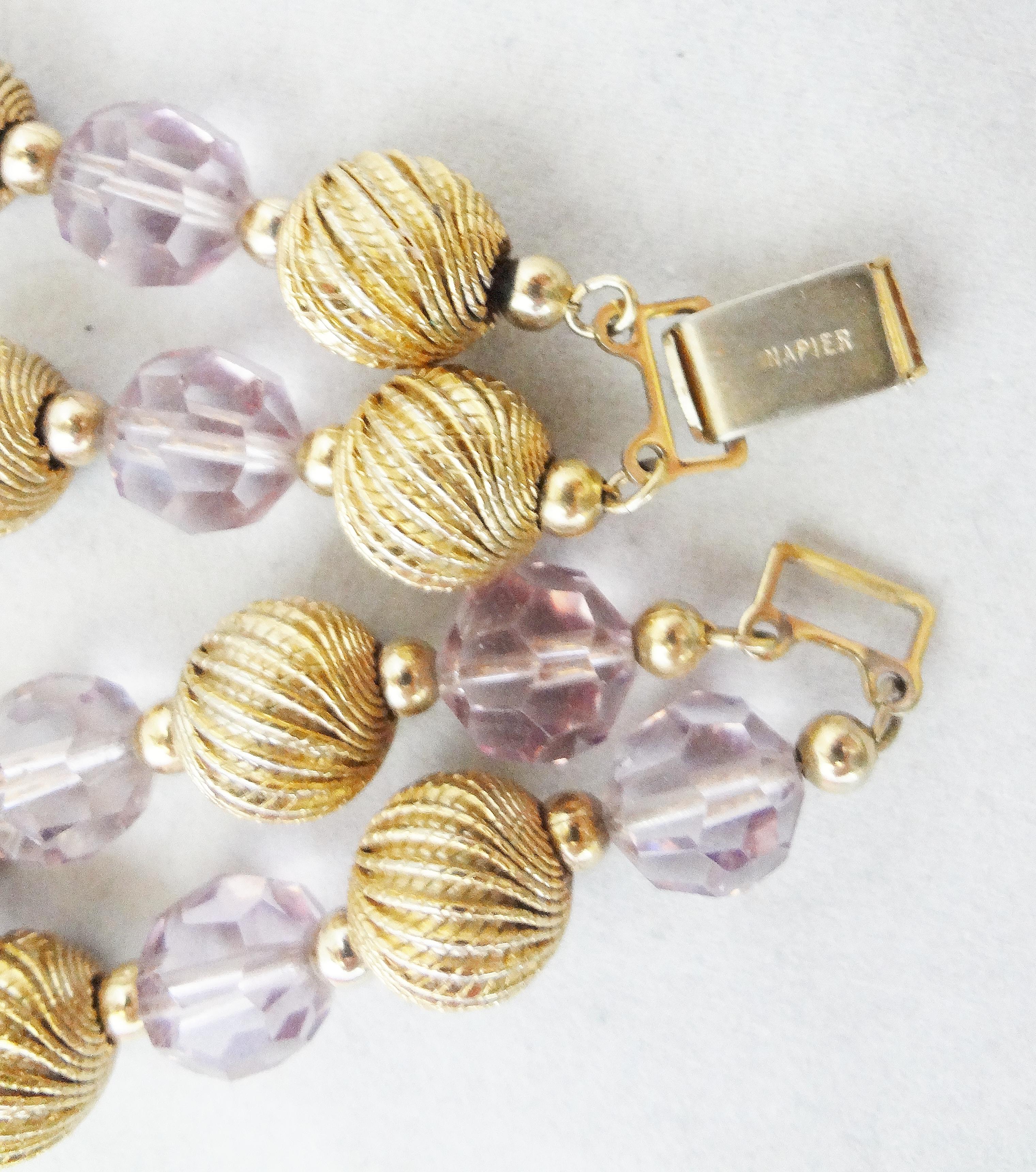 Goldtone and purple faceted bead bracelet with fold-over clasp. Marked 