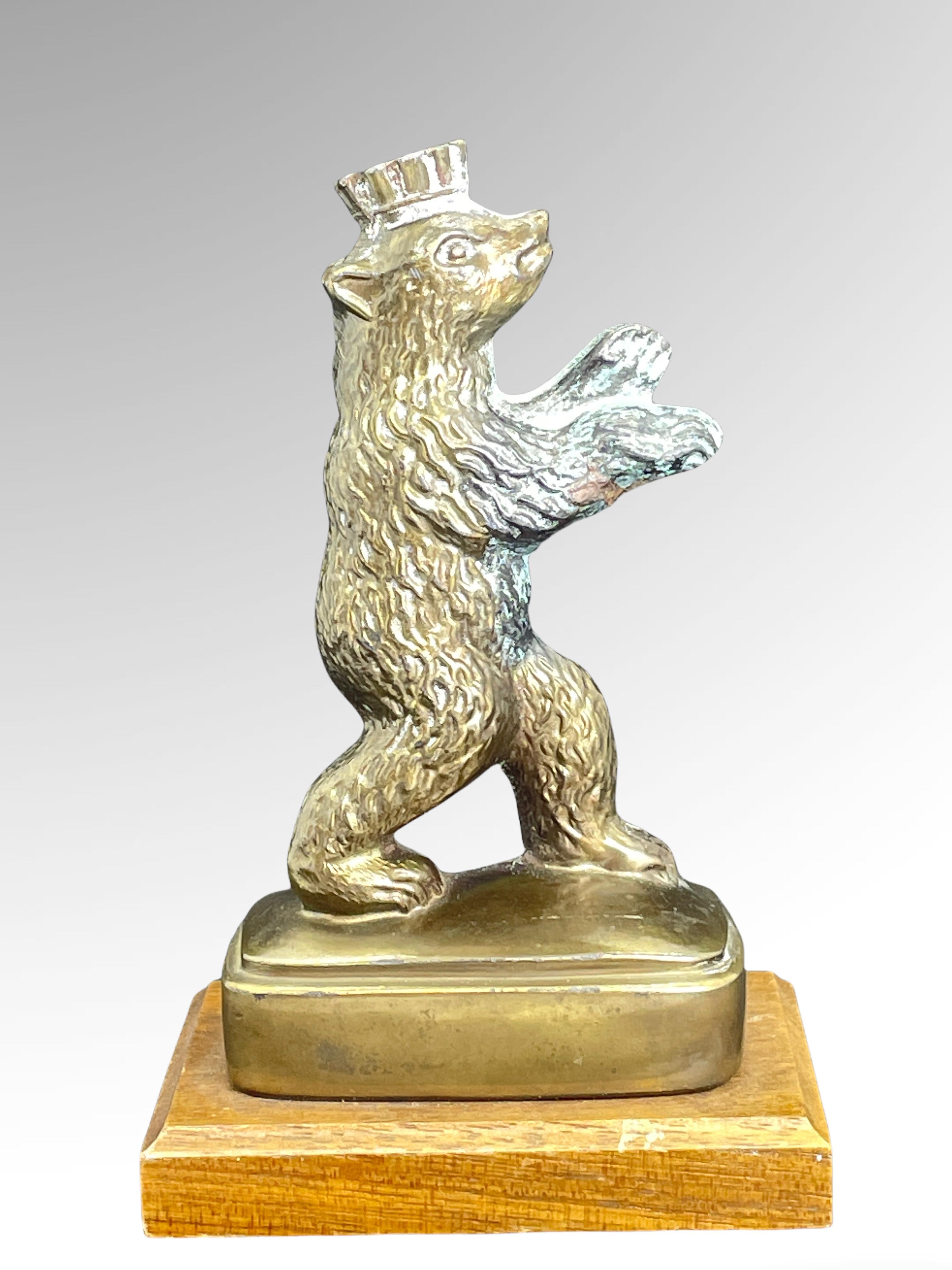 A classic decorative Berlin bear statue. Some wear with a nice patina, but this is old-age. Made of metal, fixed on a wooden base. This item was bought as a souvenir in Berlin and was made in the mid-20th century probably to the end of 1960s.