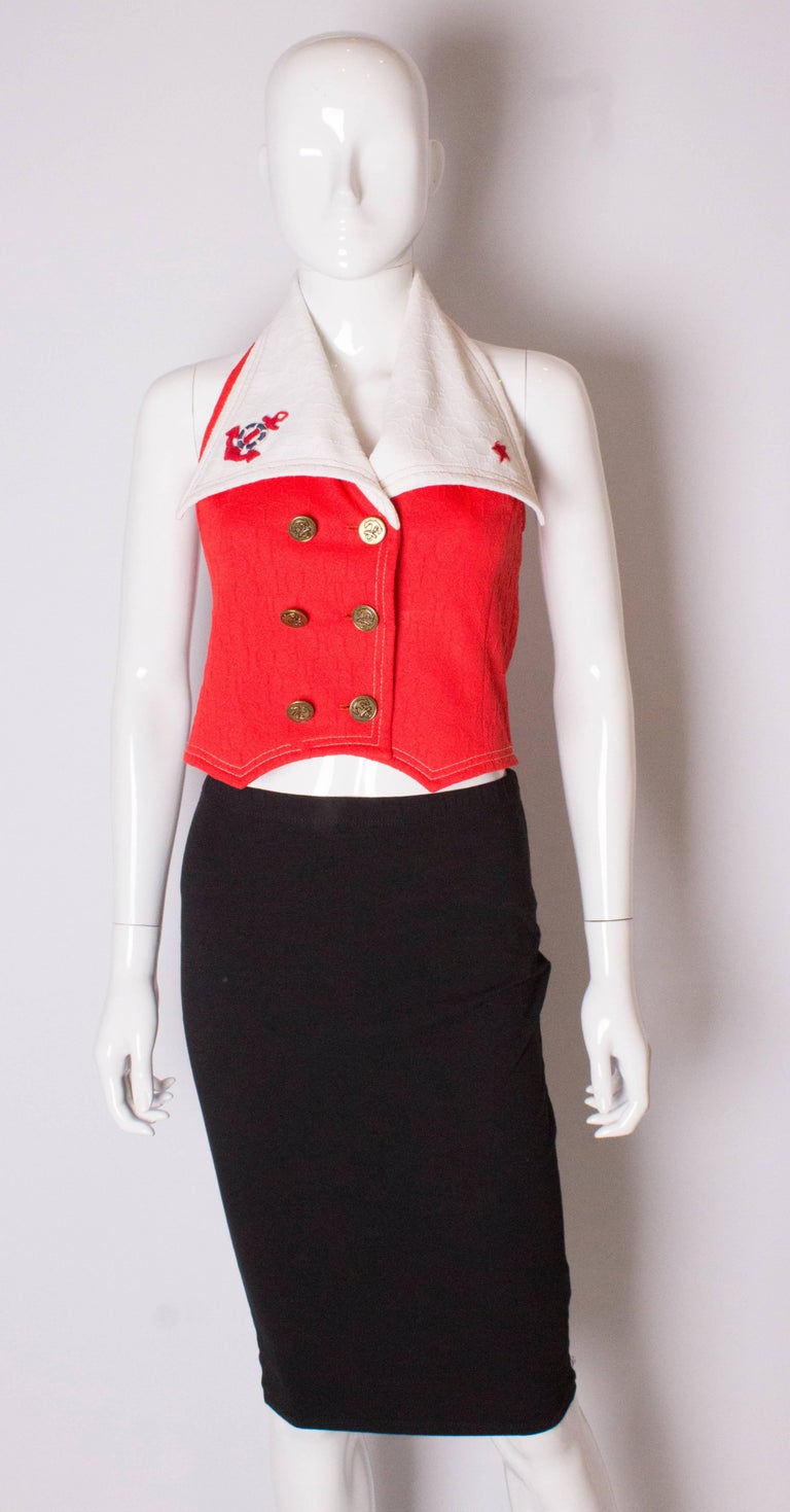 A great vintage top for Summer.  It has a halter neck and white collar, with a 6 button double breasted front opening.