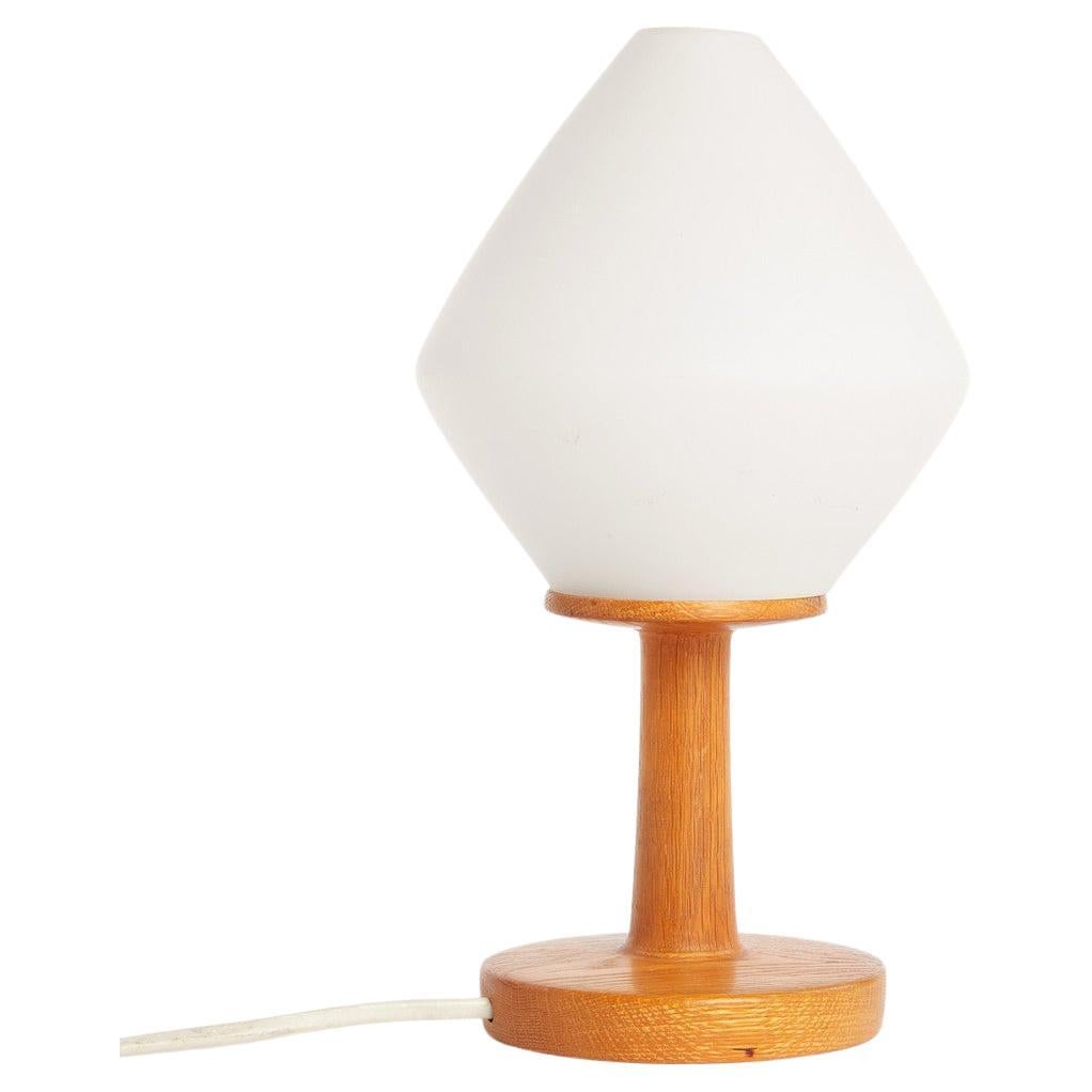 Vintage Mid-Century Modern table lamp from Sweden

1930's 
Oak base with frosted glass shade.

