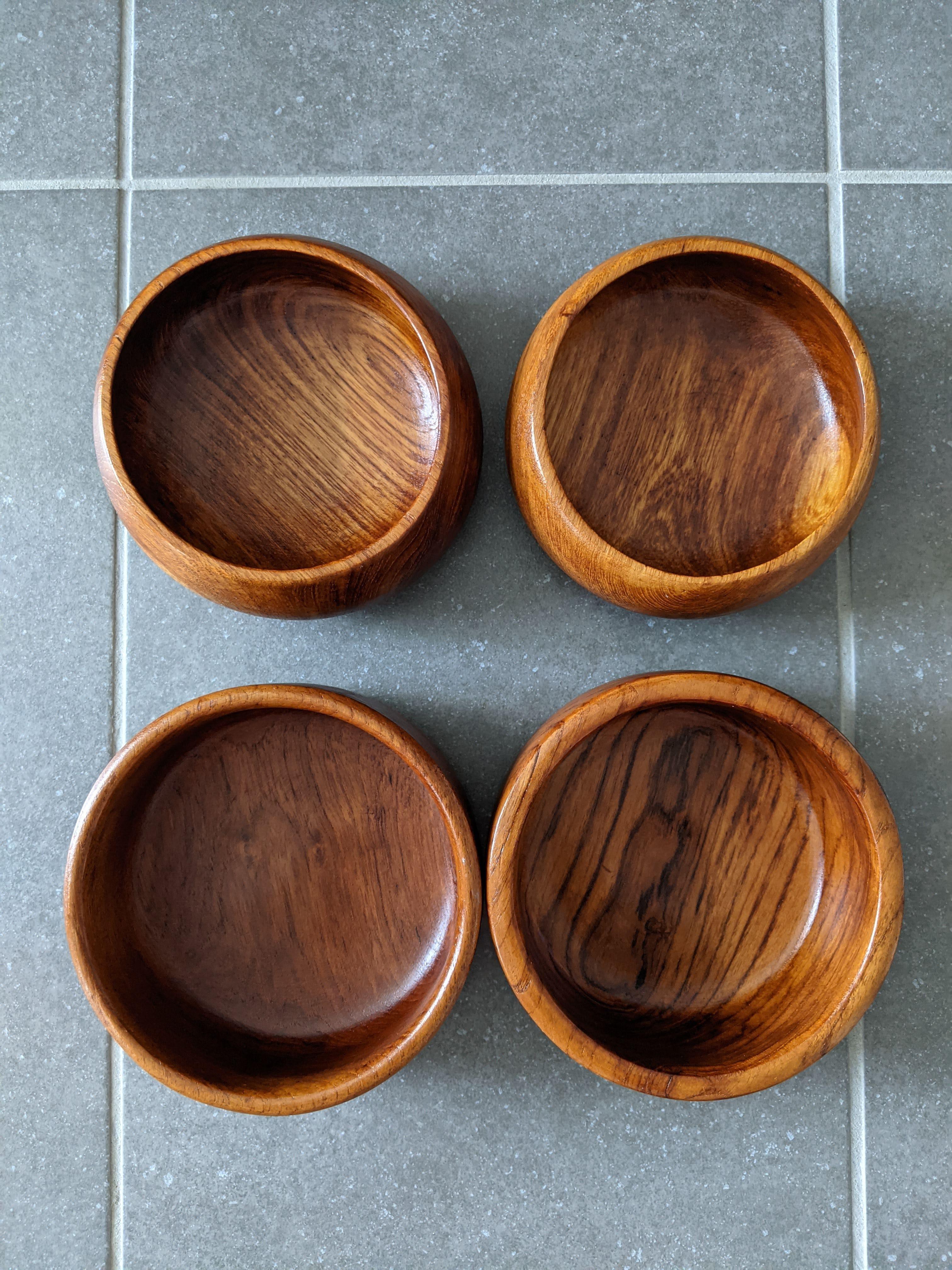 Set of 4 teak bowls in the style of Jens Quistgaard for Dansk.

2 bowls are curved and round in shape, 2 bowls are flat and straight.

Lots of lovely teak color and figure in these bowls, look great from any angle.