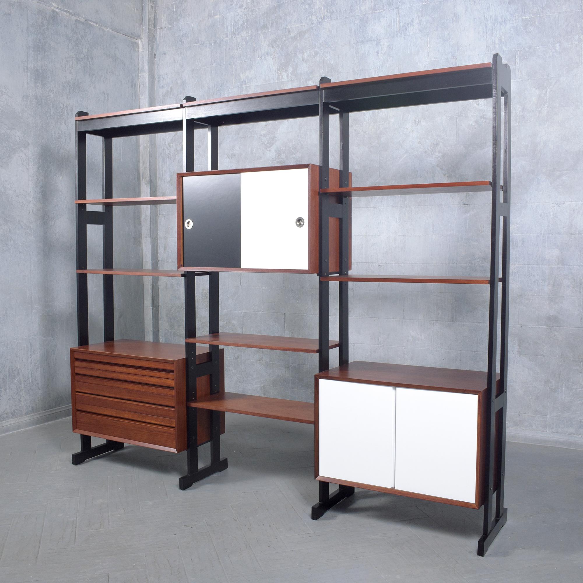 Step back into the stylish 1960s with our mid-century modern freestanding wall unit, a masterpiece of design and craftsmanship. Hand-crafted from high-quality teak, this piece has been expertly restored and refinished by our team of professional