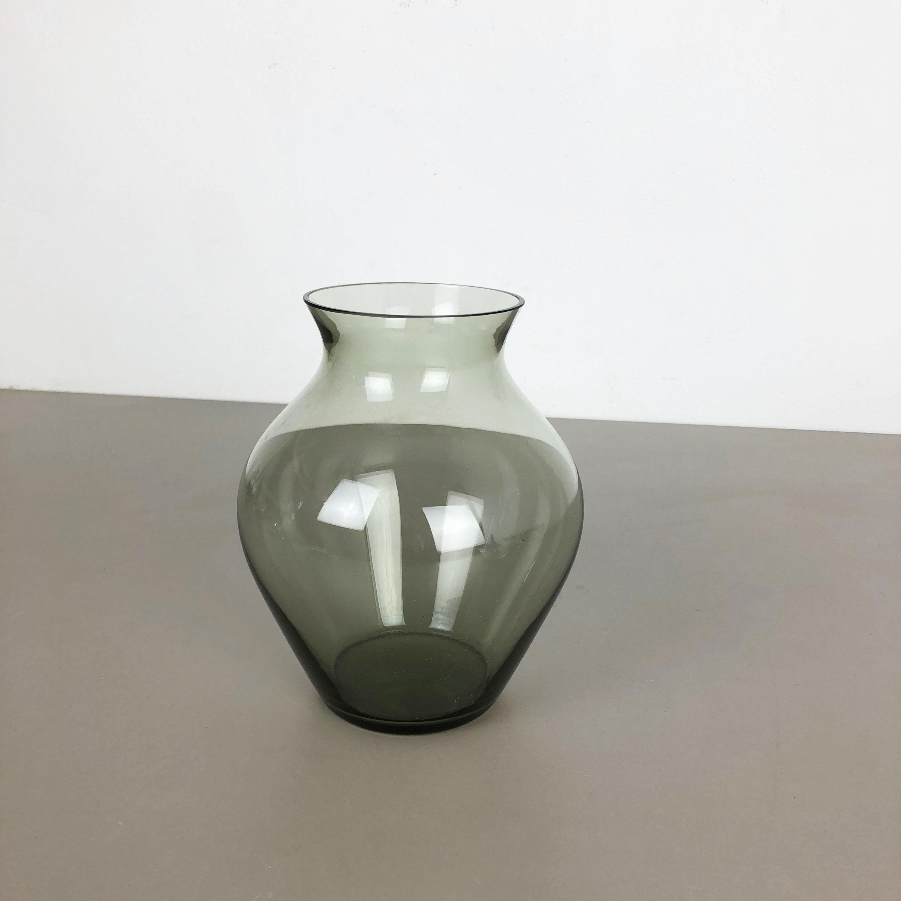 Article:

Glass vase


Producer:

WMF Württembergische Metallwaren Fabrik in Geislingen 


Designer:

Wilhelm Wagenfeld 


Design:

WMF Turmalin series


Decade:

1960s


Description:

Original vintage 1960s vase of the