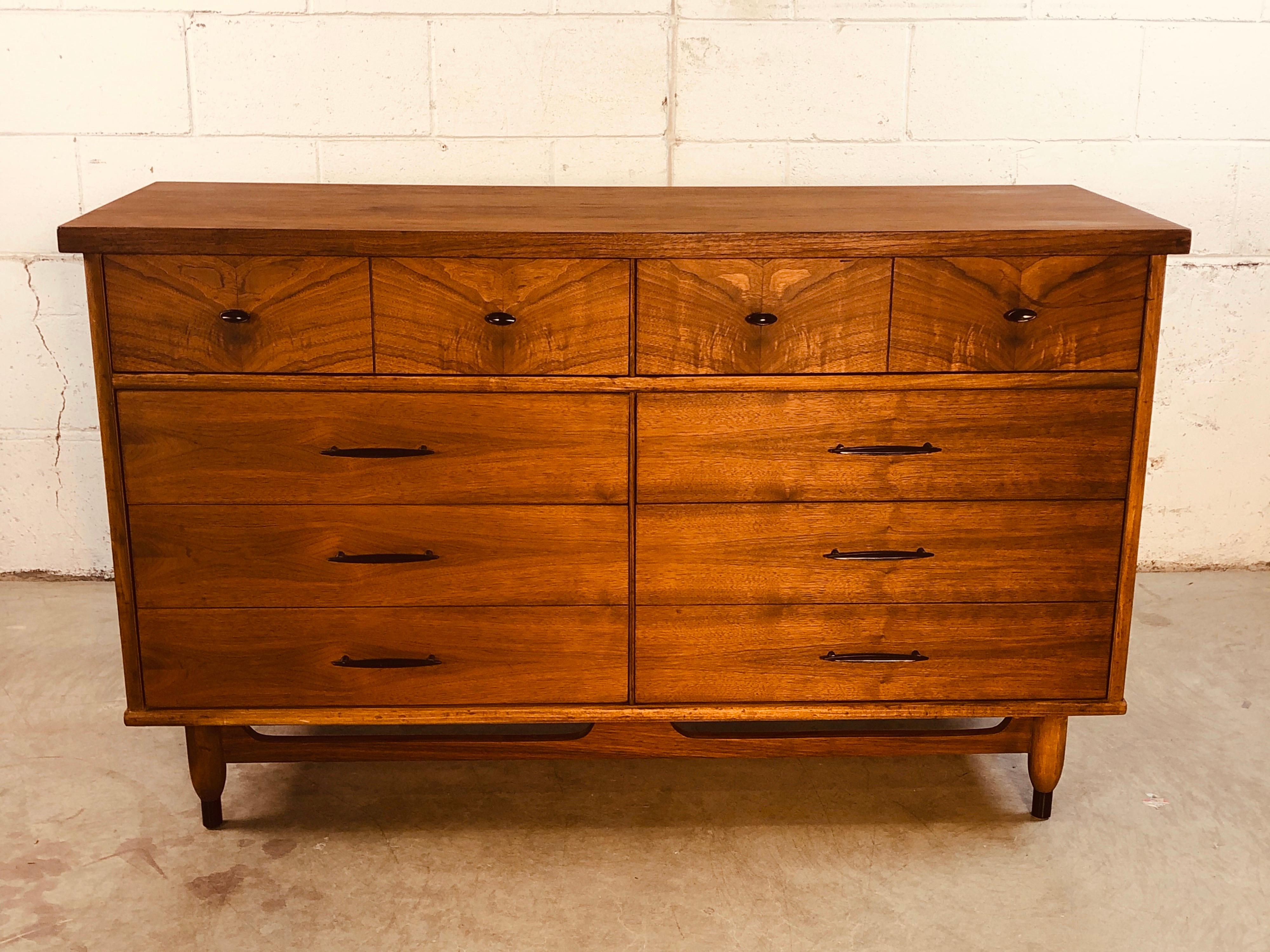 Vintage 1960s walnut wood 8-drawer low dresser with black metal pulls. The dresser is newly refinished and in excellent condition. No marks.