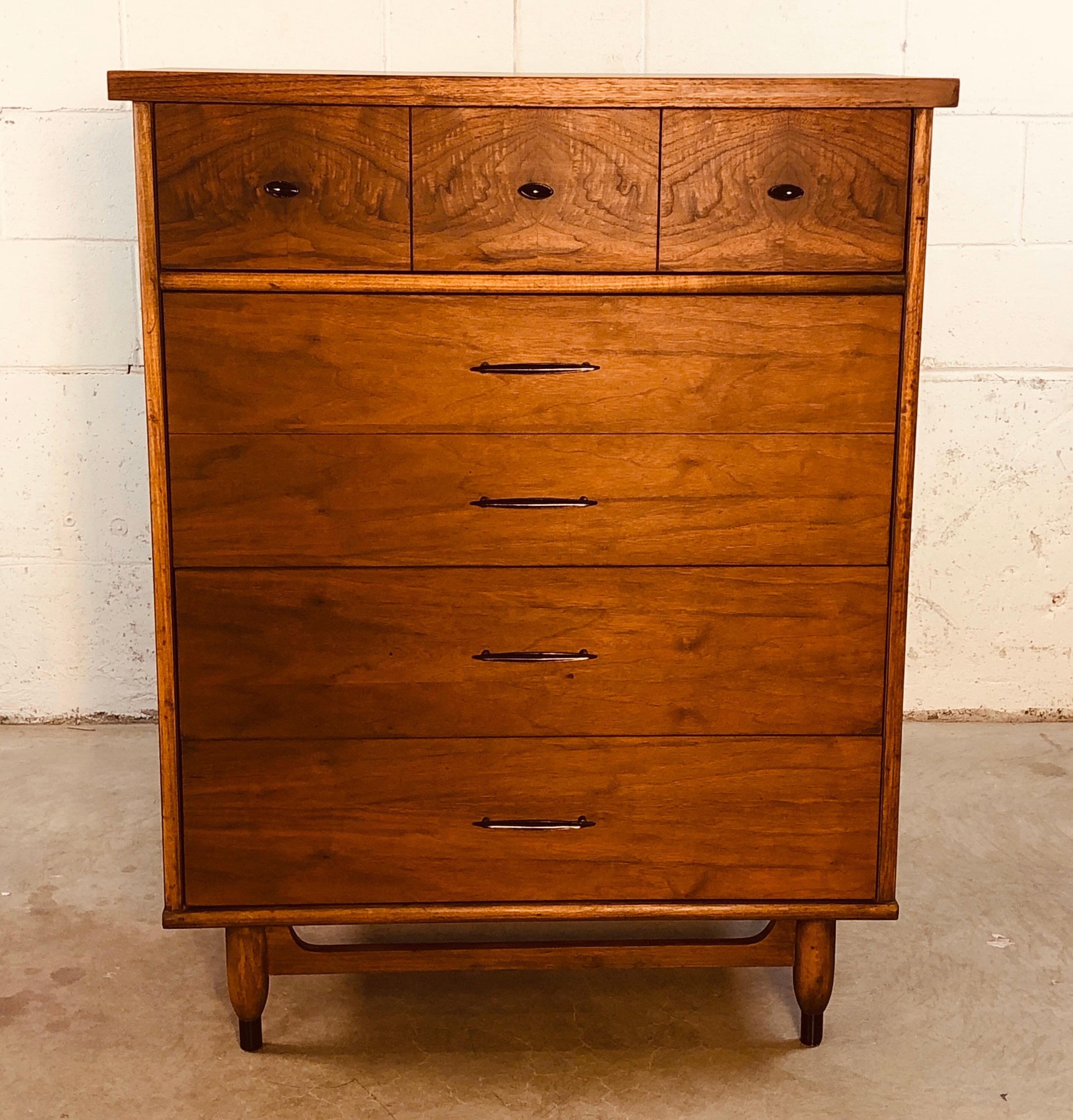 Vintage 1960s walnut wood tall dresser with four drawers and black metal pulls. One drawer is double sized for deeper storage. Fully restored and refinished. No makers mark but labeled “Swedish Walnut” on the back.