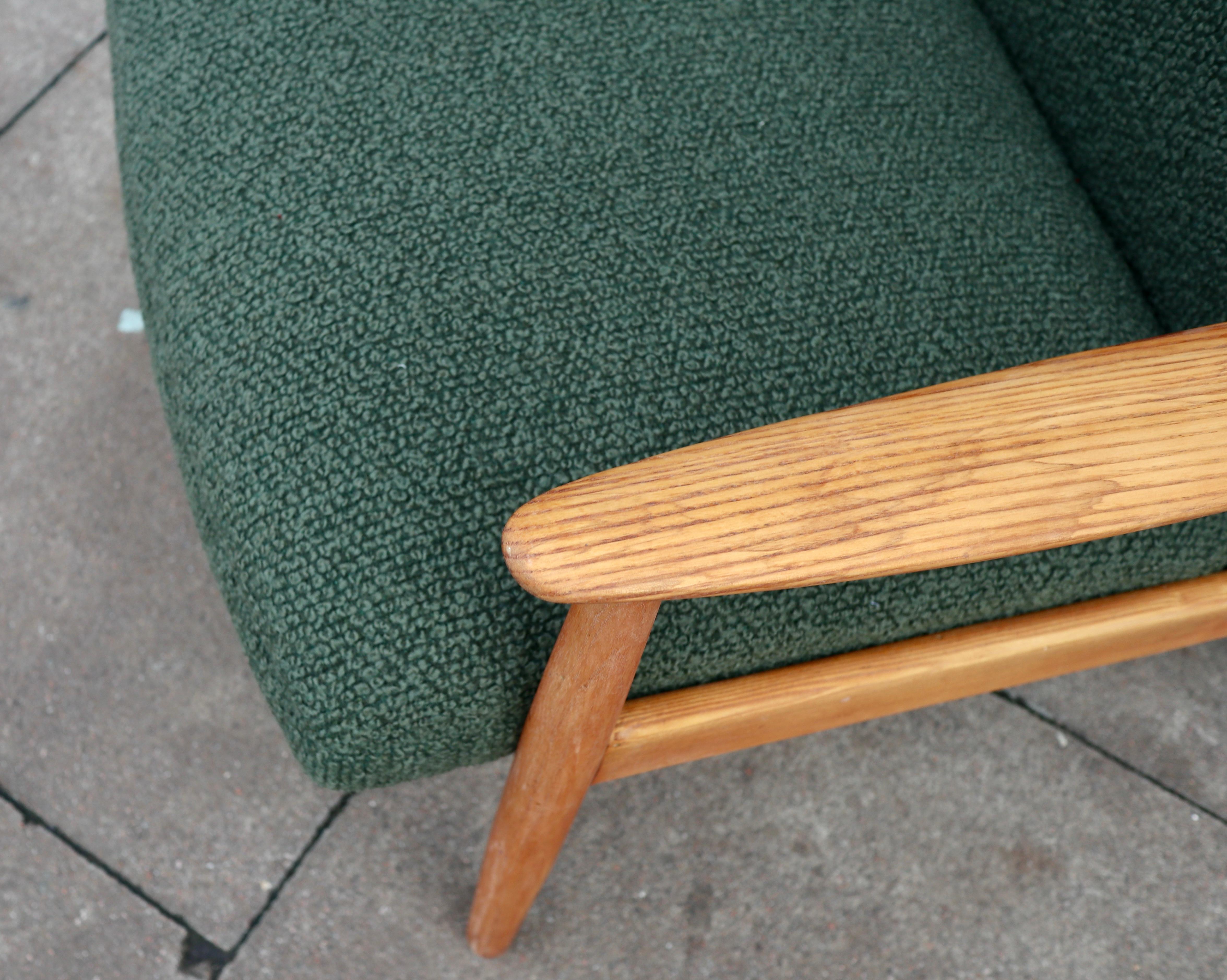 Vintage 1960s wood framed Danish lounge chair upholstered in moss green boucle. For Sale 1