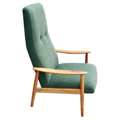 Retro 1960s wood framed Danish lounge chair upholstered in moss green boucle.