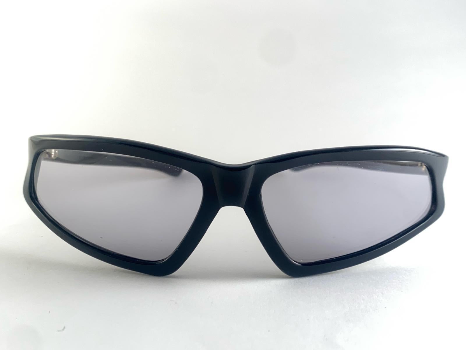 Vintage 1960'S Wrap Around Mask Black Sleek Sunglasses.

This Item Has Minor Sign Of Wear On The Frame Due To Storage.

Measurements 

Front : 18 Cms 
Lens Height : 3.5 Cms
Lens Width : 6.5 Cms
Temples : 11.5 Cms 

Vintage 1960'S Wrap Around Sleek