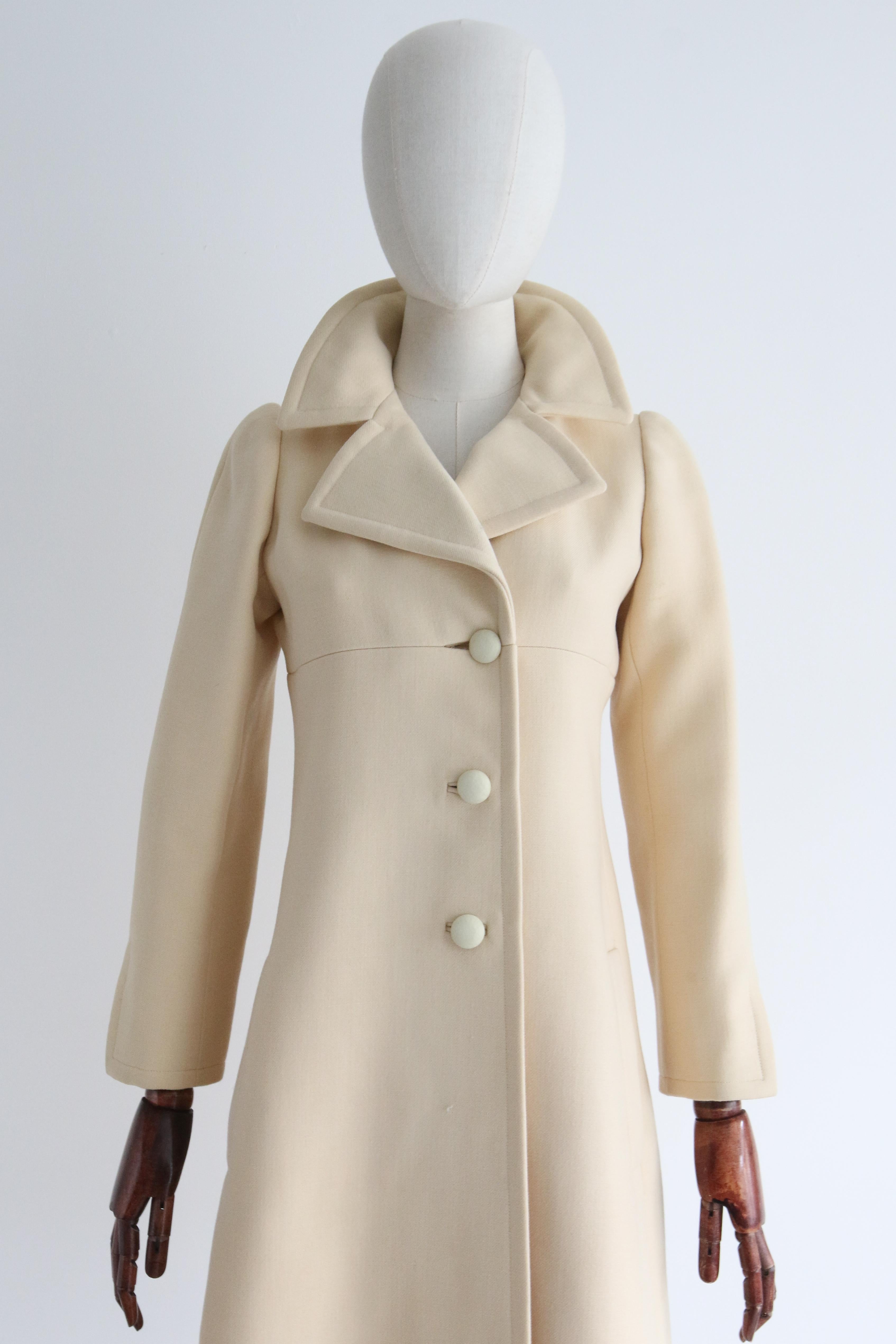 A rare and unique piece to behold, this original vintage 1960's Yves Saint Laurent Coat, Rendered in a cream wool and lined in silk, is just the piece to add to your couture collection and seasonal wardrobe.

The wide notched pointed collar frames